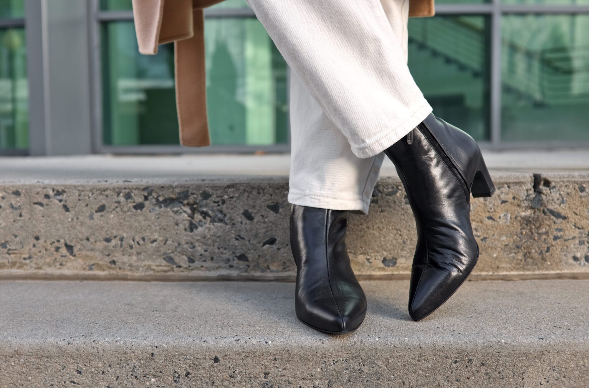 Alyssa crosses her ankles while wearing the boots from Poppy Barley