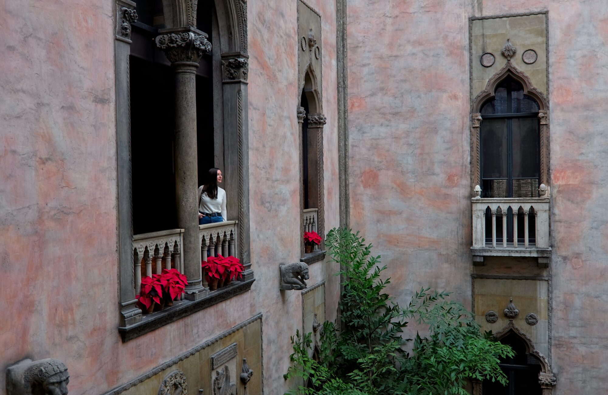 Alyssa wears a white sweater and blue jeans at the Gardner Museum