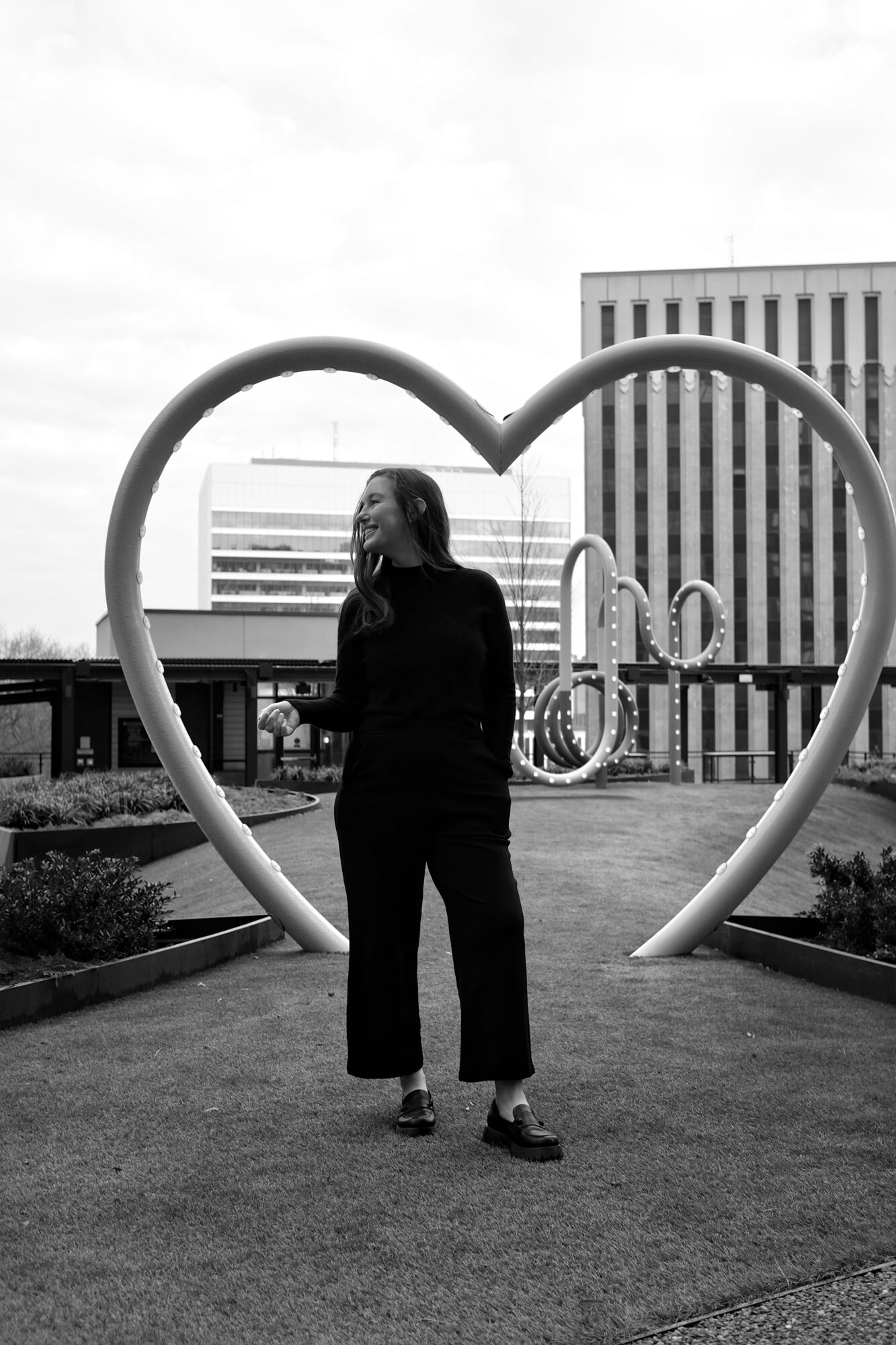 Alyssa stands under a heart sculpture
