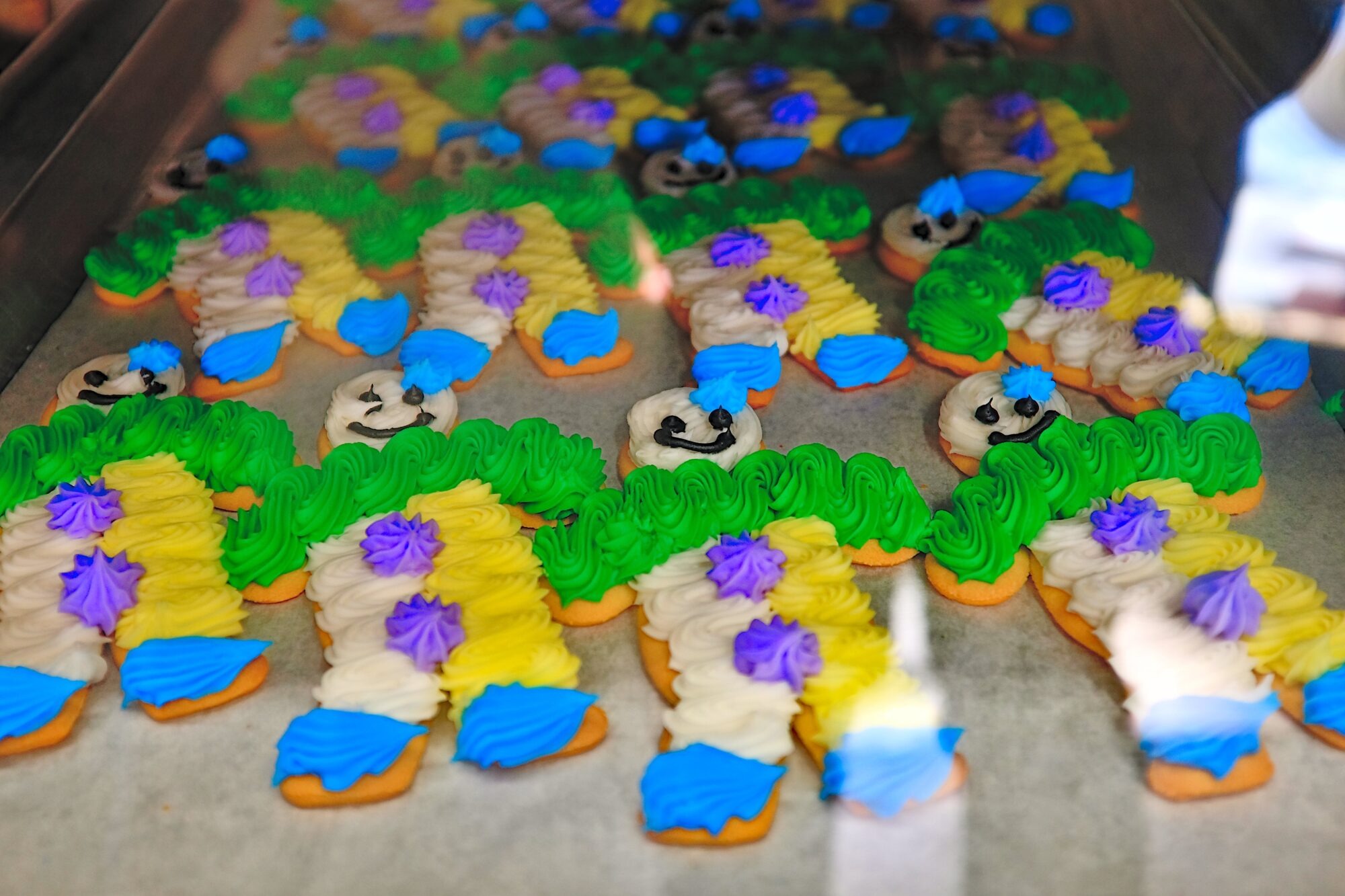 A tray of cookies decorated like clowns