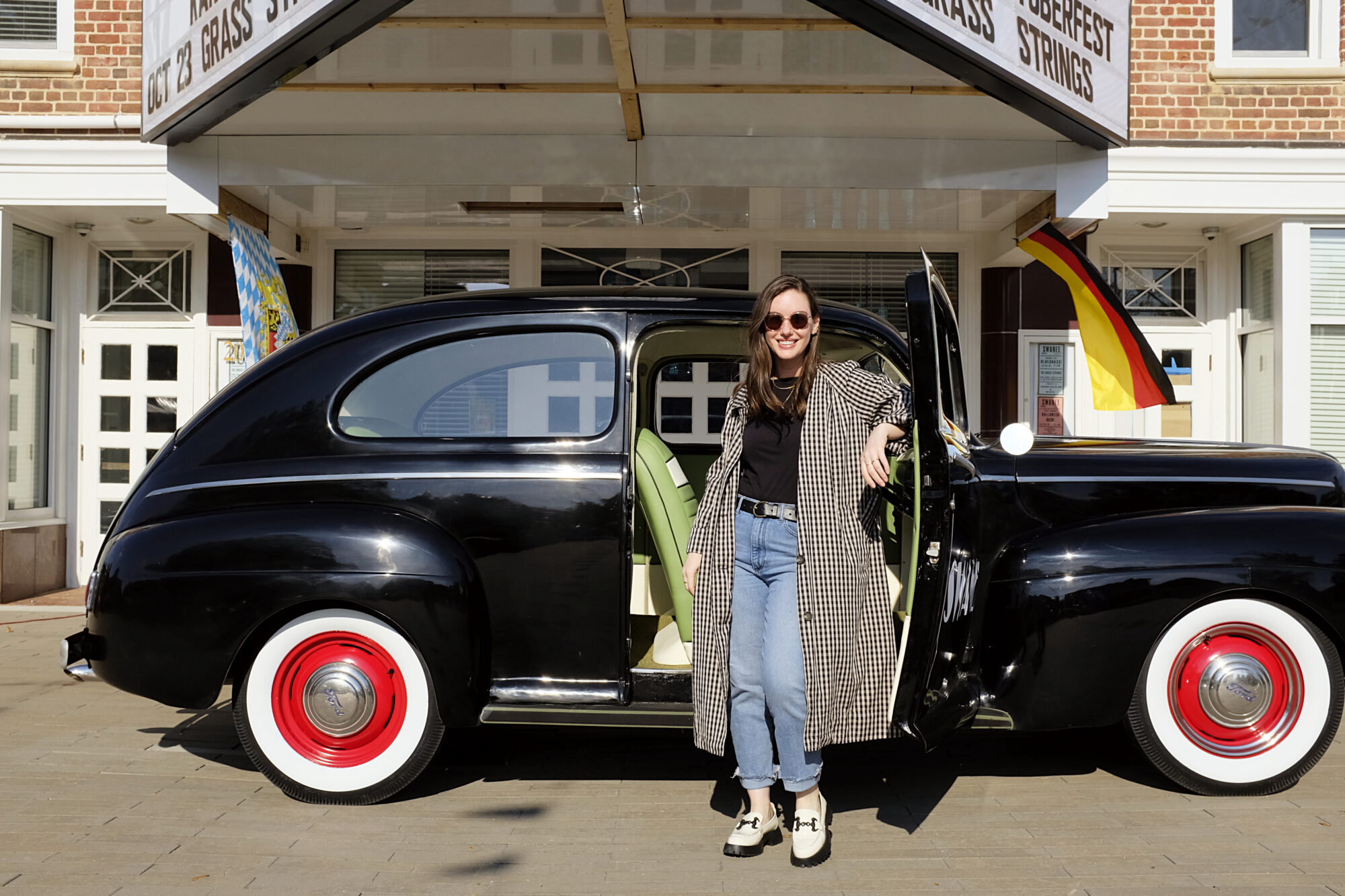 Alyssa stands outside of a vintage car in Kannapolis