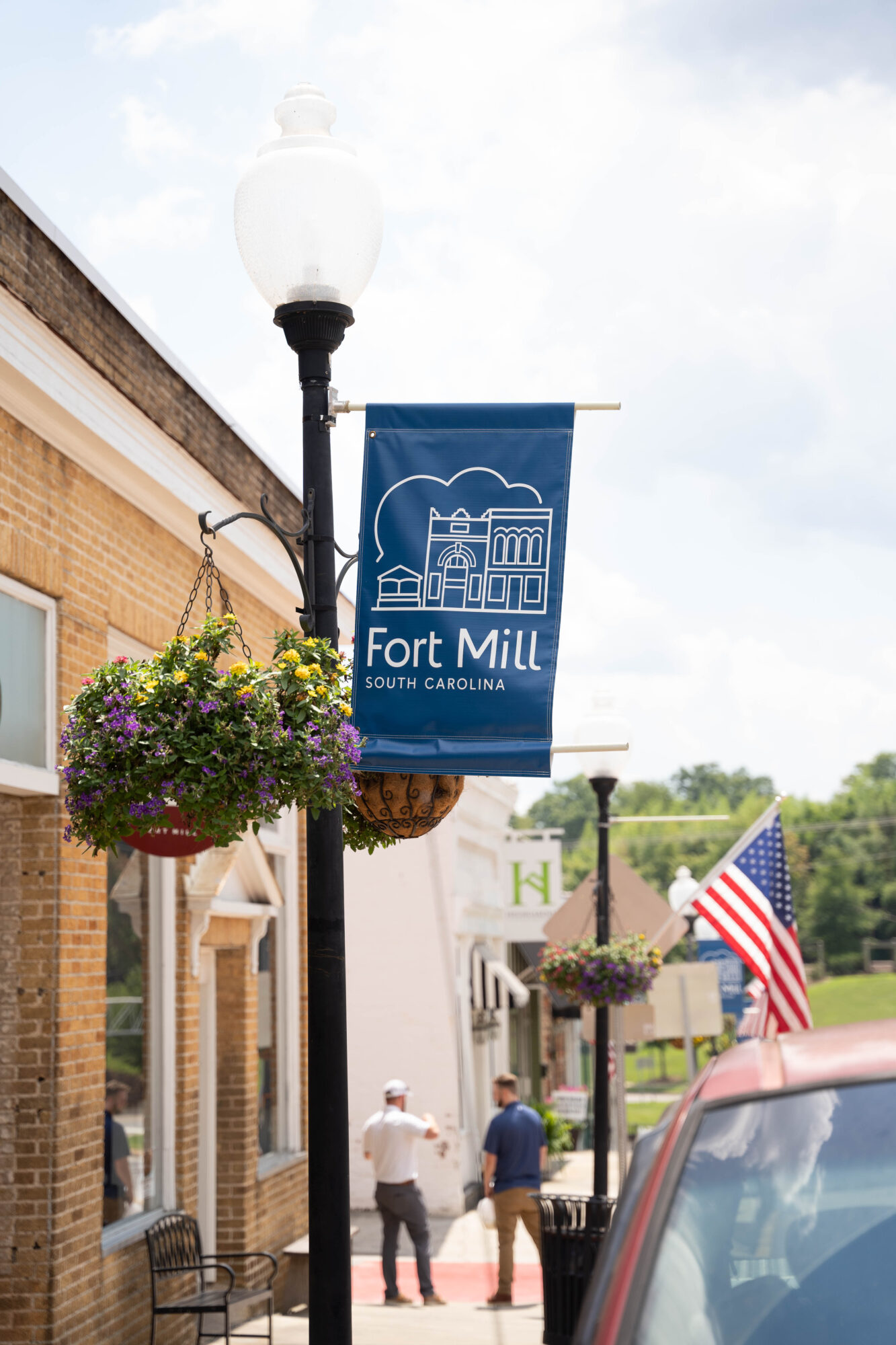 A lamppost with a sign that reads "Fort Mill"