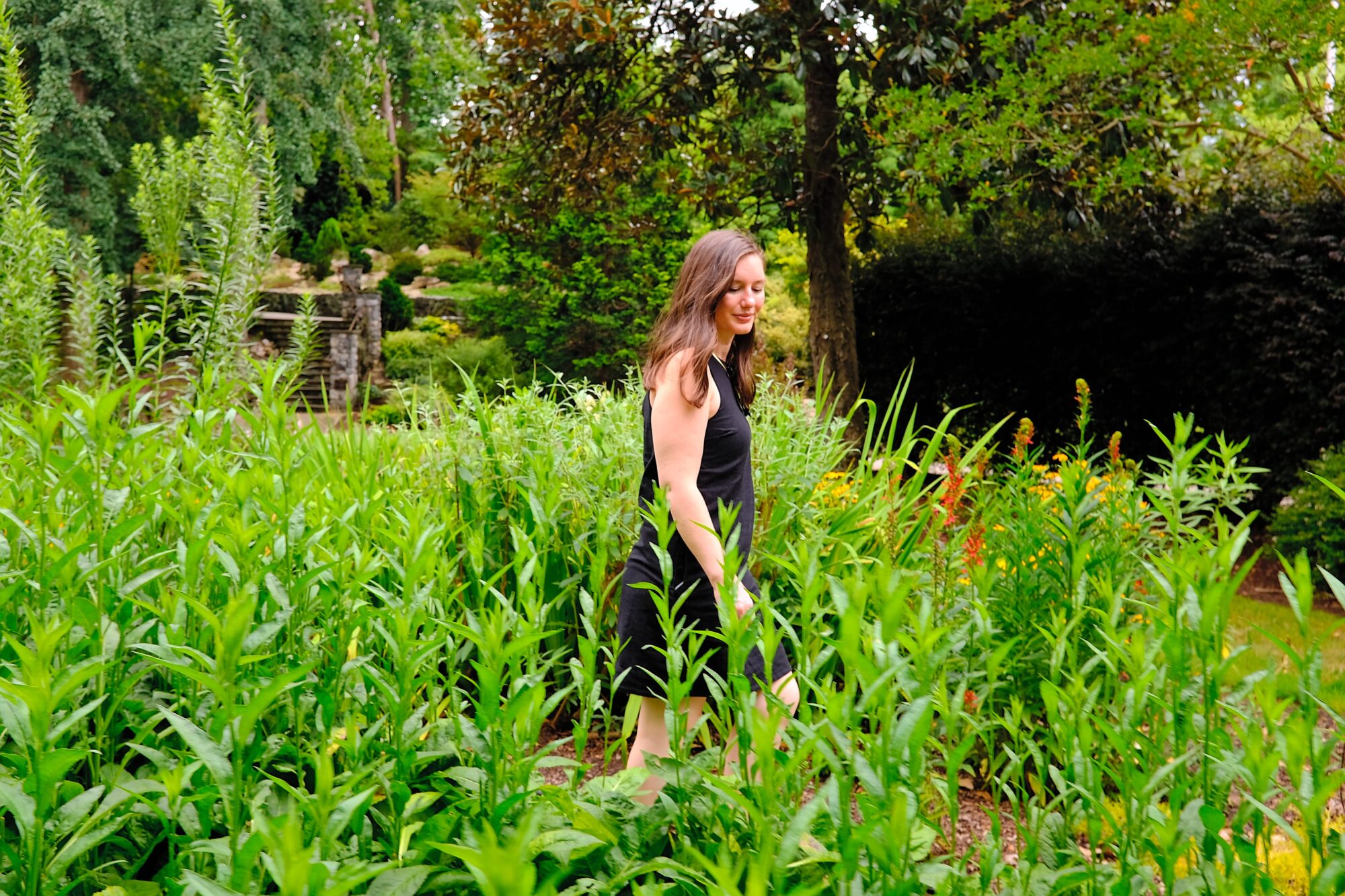 Alyssa walks through a garden in Greensboro