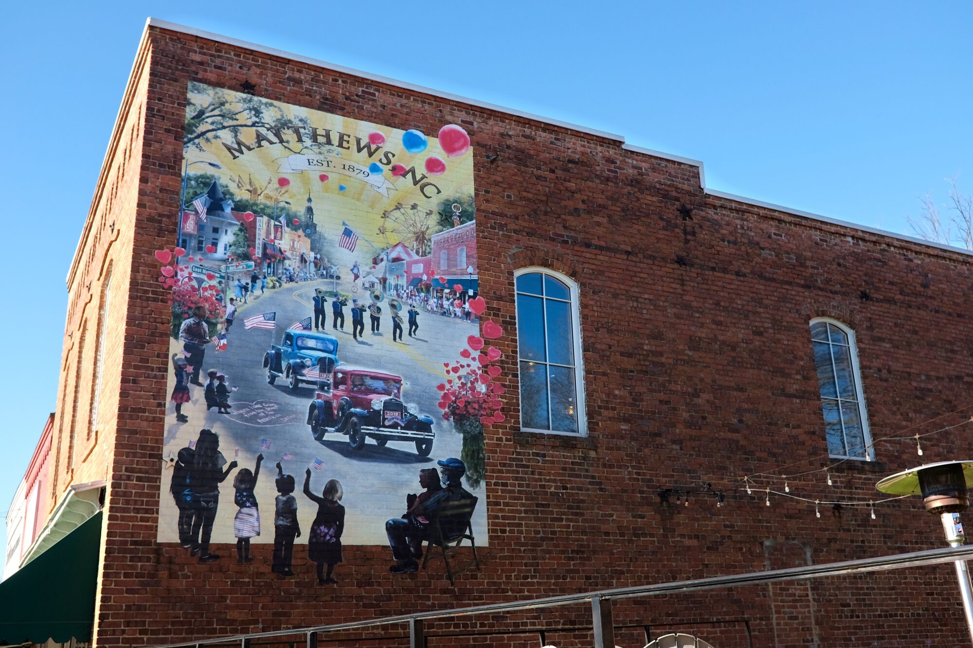 A brick wall with a Matthews mural