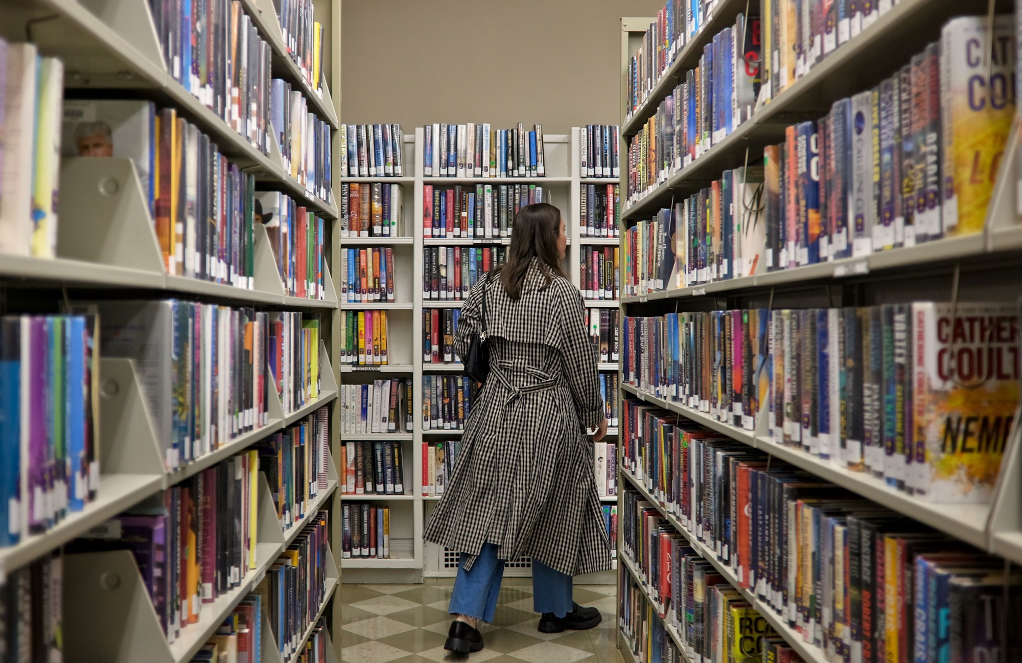 Alyssa walks through a library