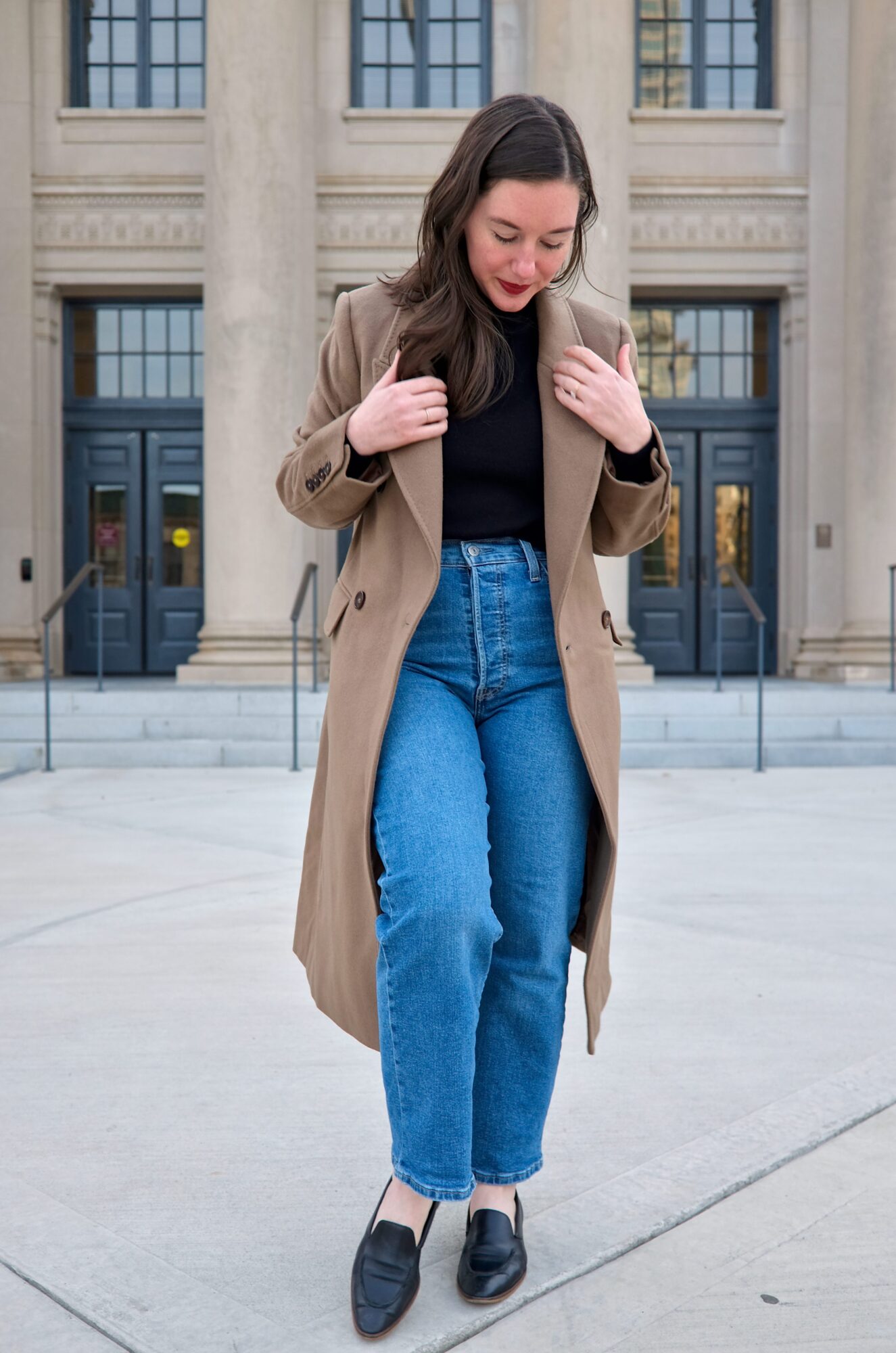 Alyssa wears the Italian Wool Double-Breasted Coat with jeans and a black top and pulls the lapels in closer