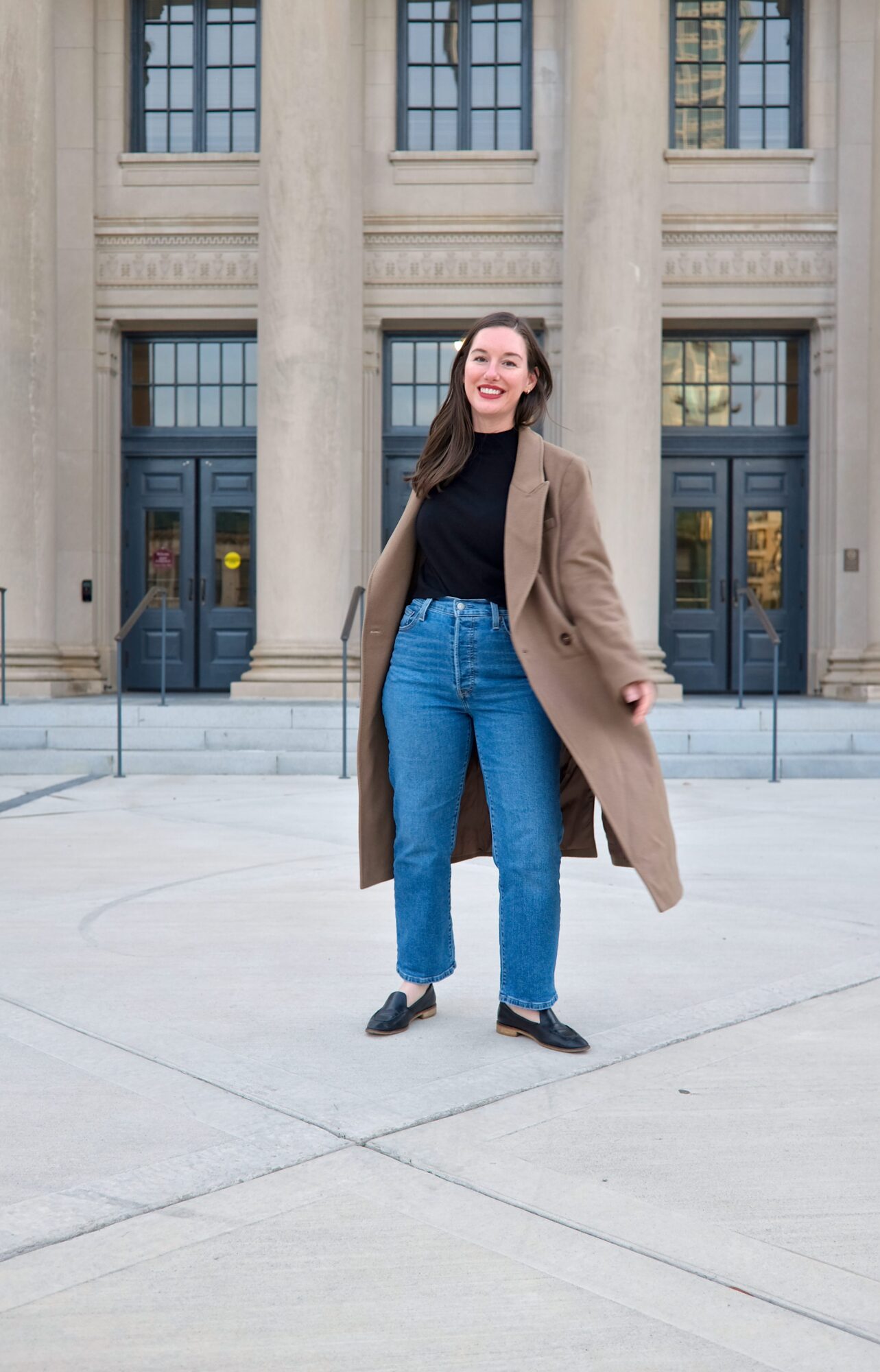 Alyssa wears the Italian Wool Double-Breasted Coat with jeans and a black top and twirls a little