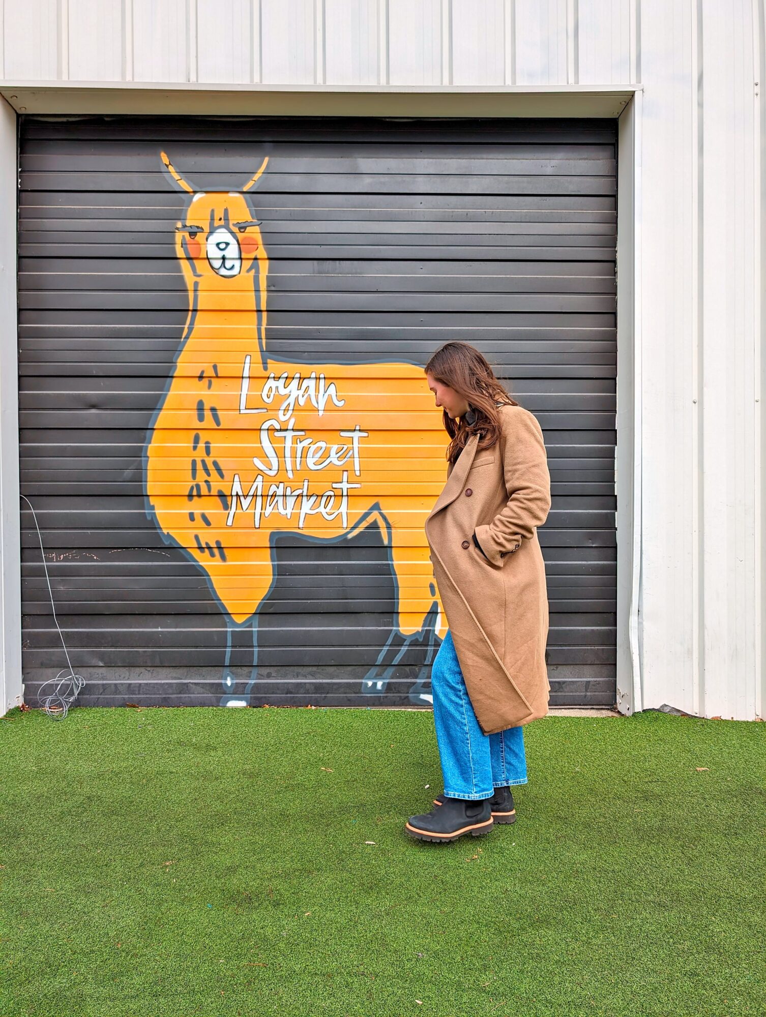 Alyssa walks outside Logan Street Market in Louisville