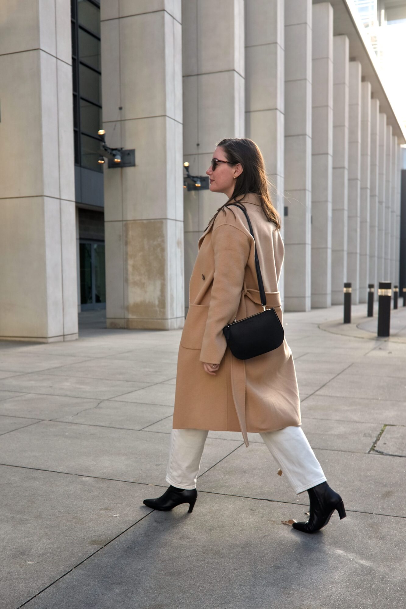 Alyssa walks with the Waverley bag slung over her shoulder 