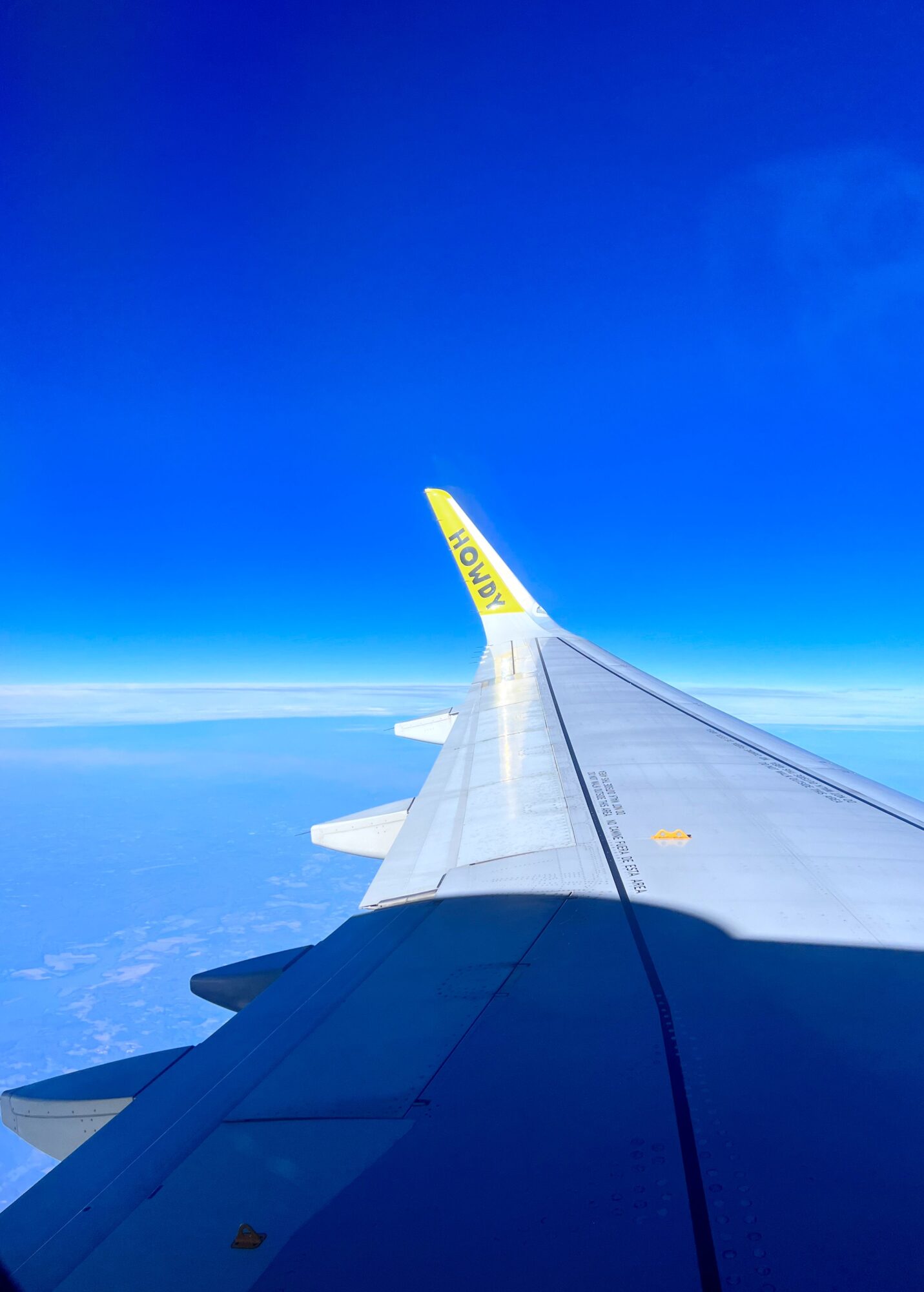 A view of the wing of a Spirit flight in the air