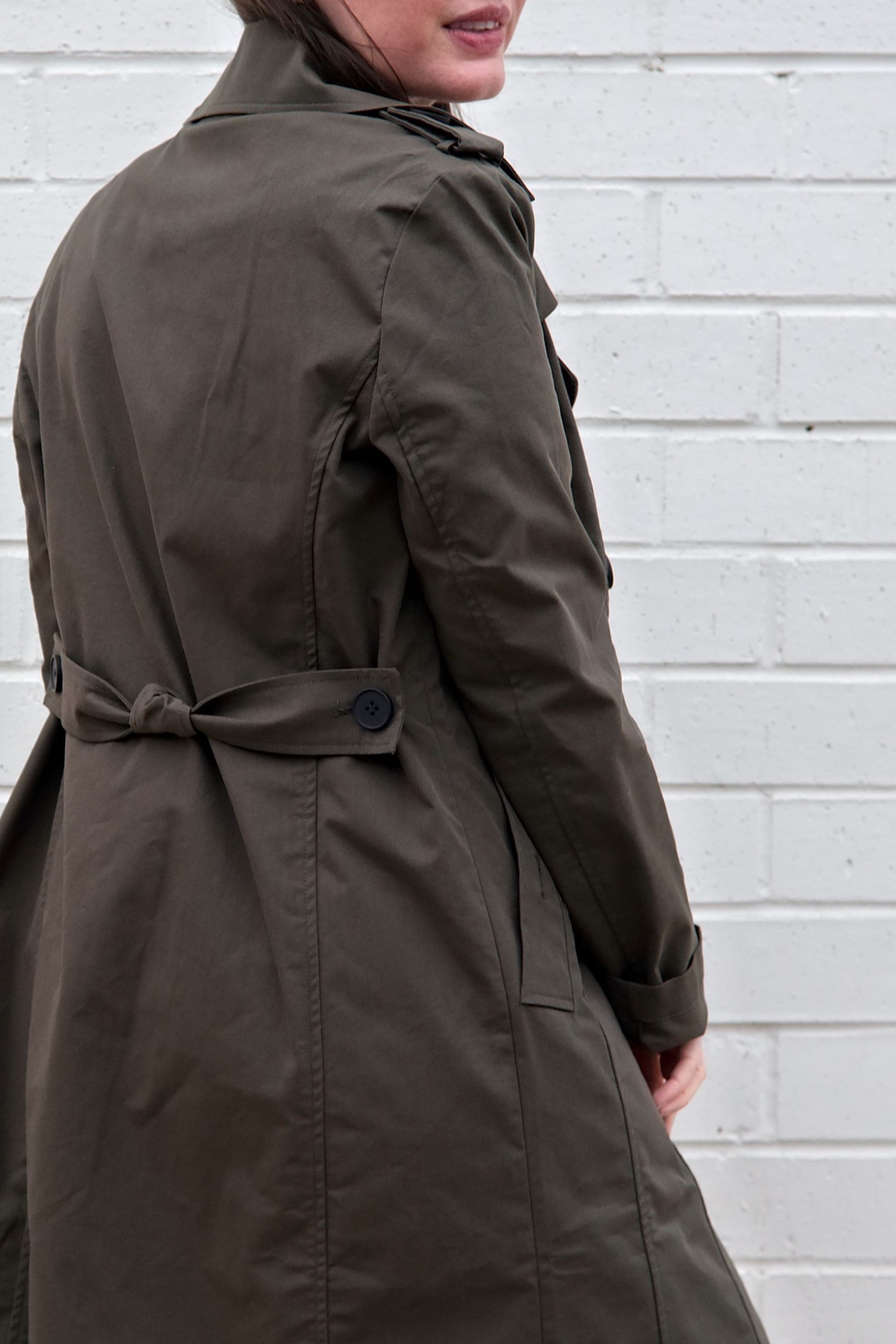 Alyssa turns to show the button belt on the back of the Derjon Trench