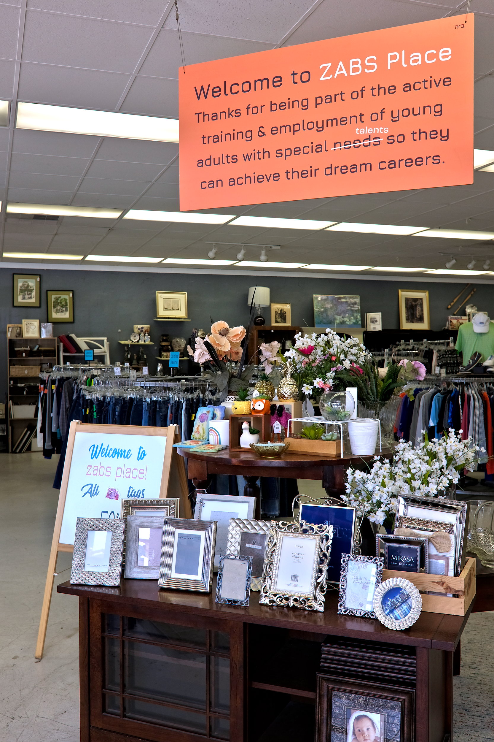 A sign in ZABS Place informs customers of the shop's mission