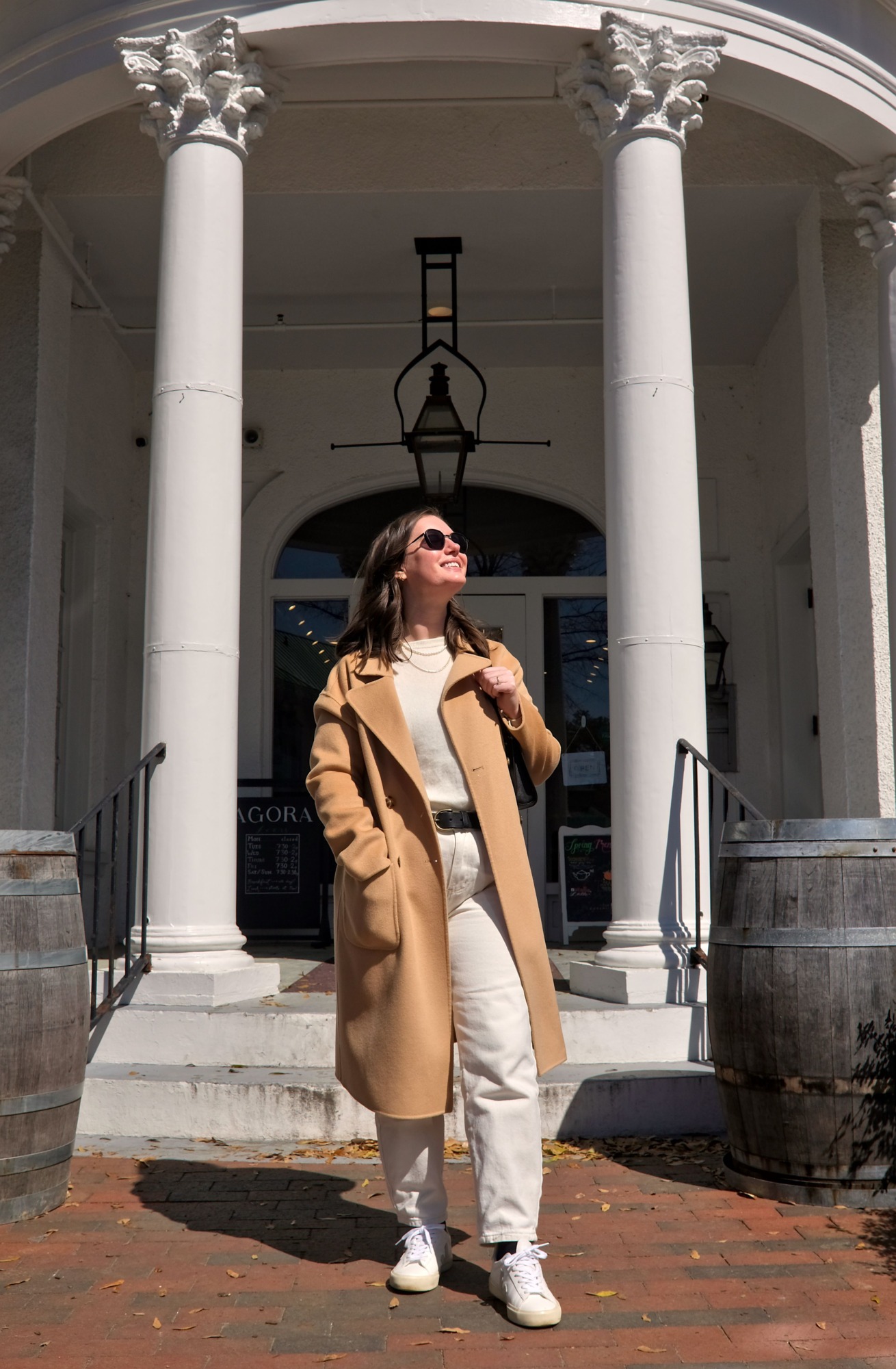 Alyssa stands on the steps of Agora in Pinehurst