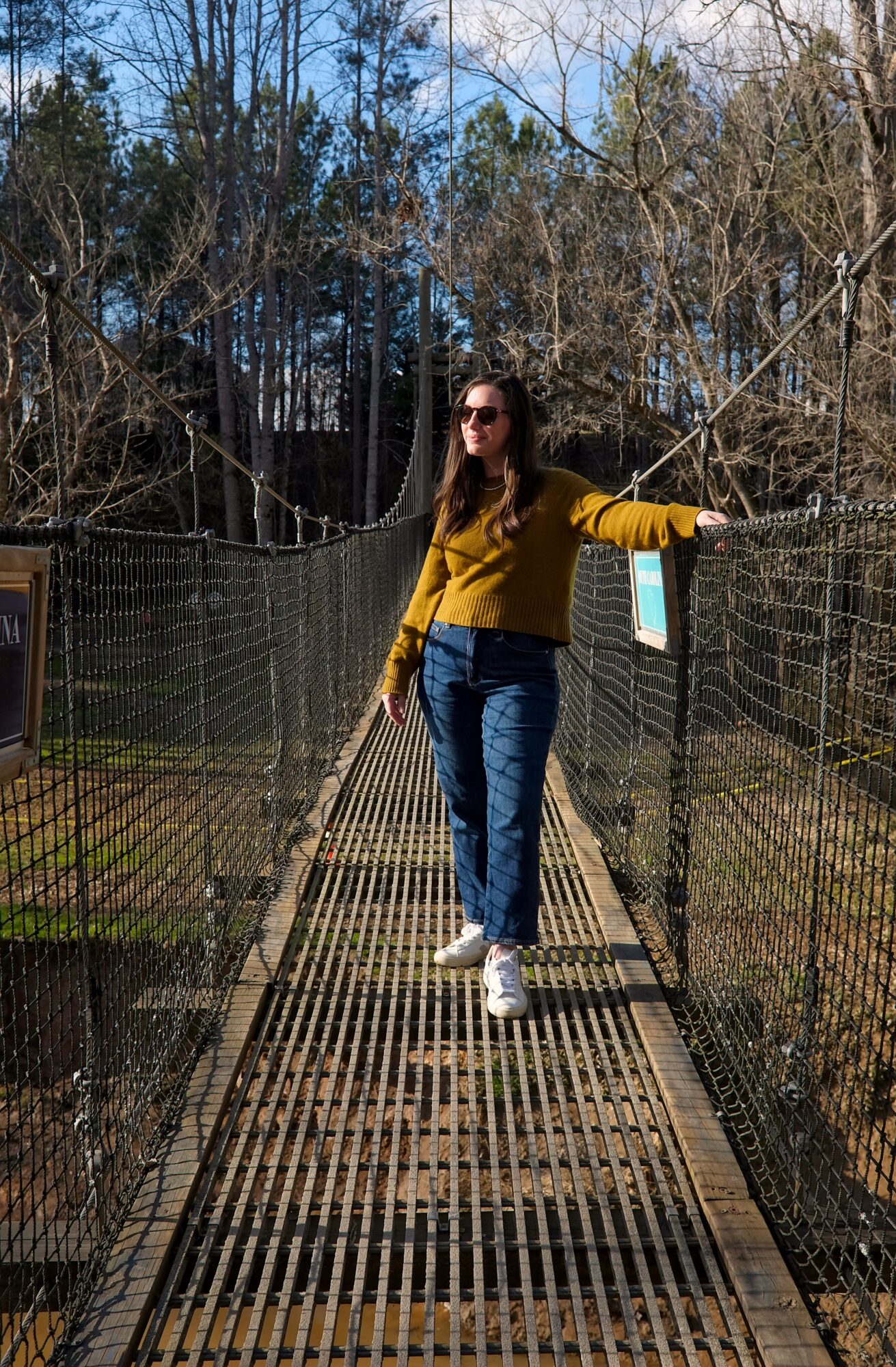 Alyssa stands on a suspension bridge on the NC/SC border