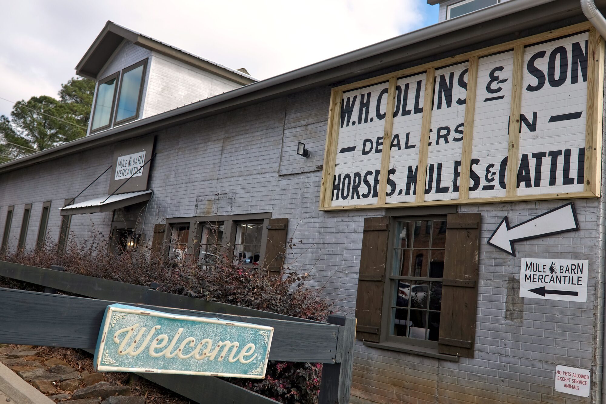 Exterior of Mule Barn Mercantile with vintage sign in front