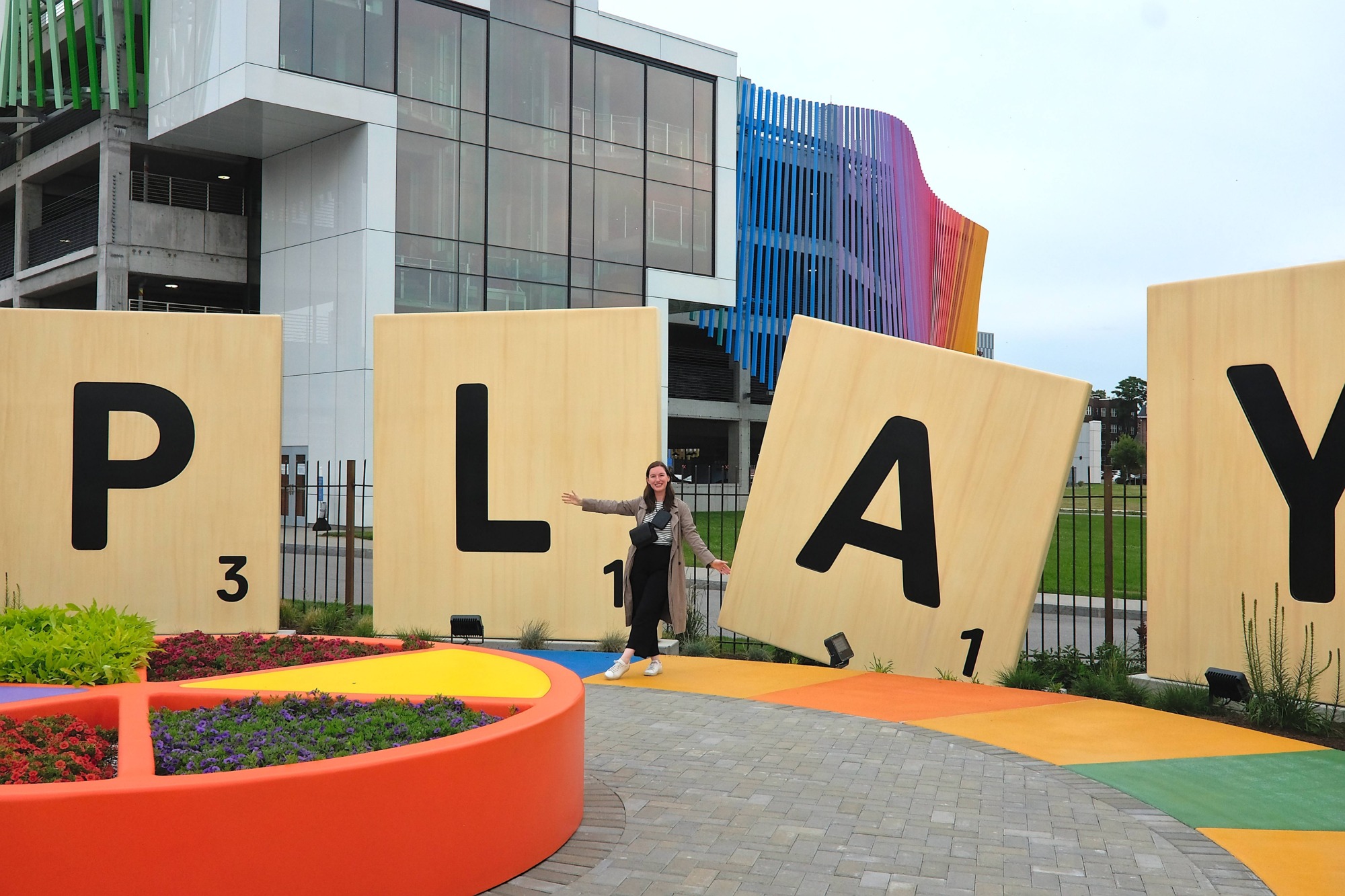 Alyssa stands by Scrabble letters that read PLAY