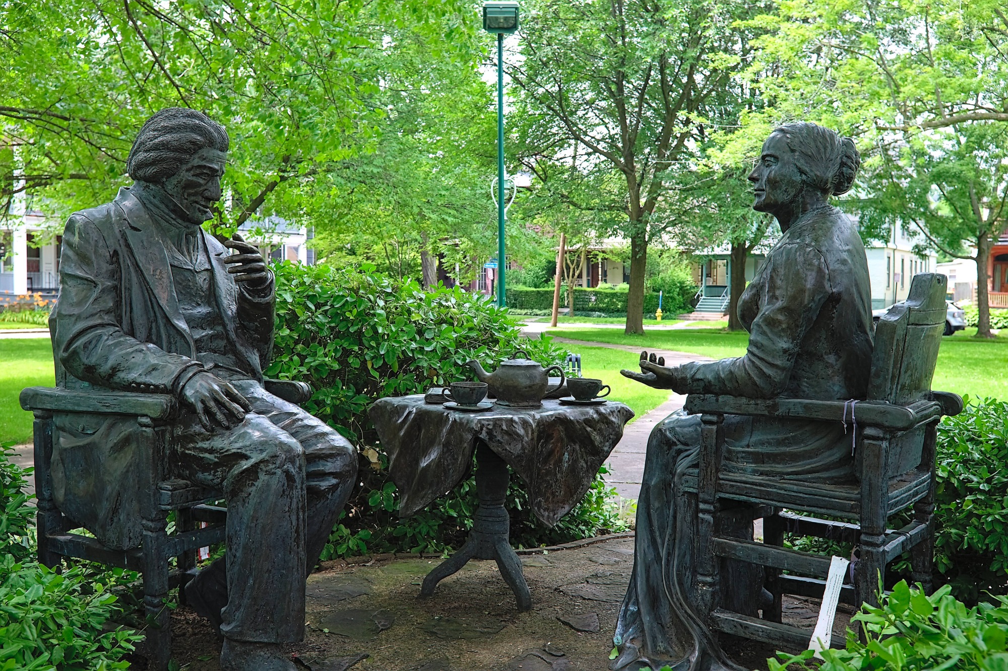 A statue of Frederick Douglass and Susan B. Anthony having tea