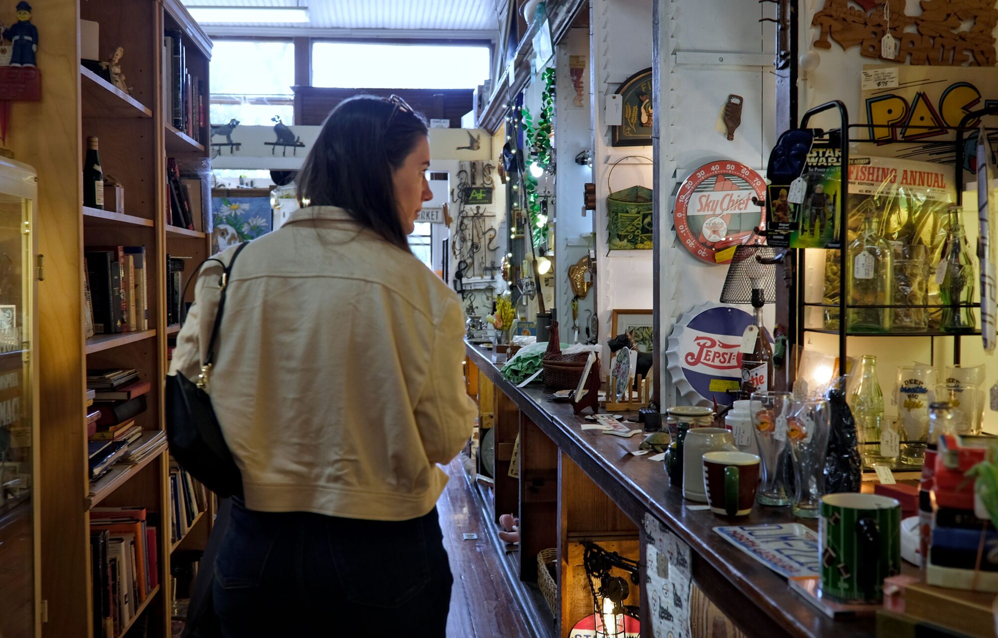 Alyssa looks at antique items at Waxhaw Antique Mart