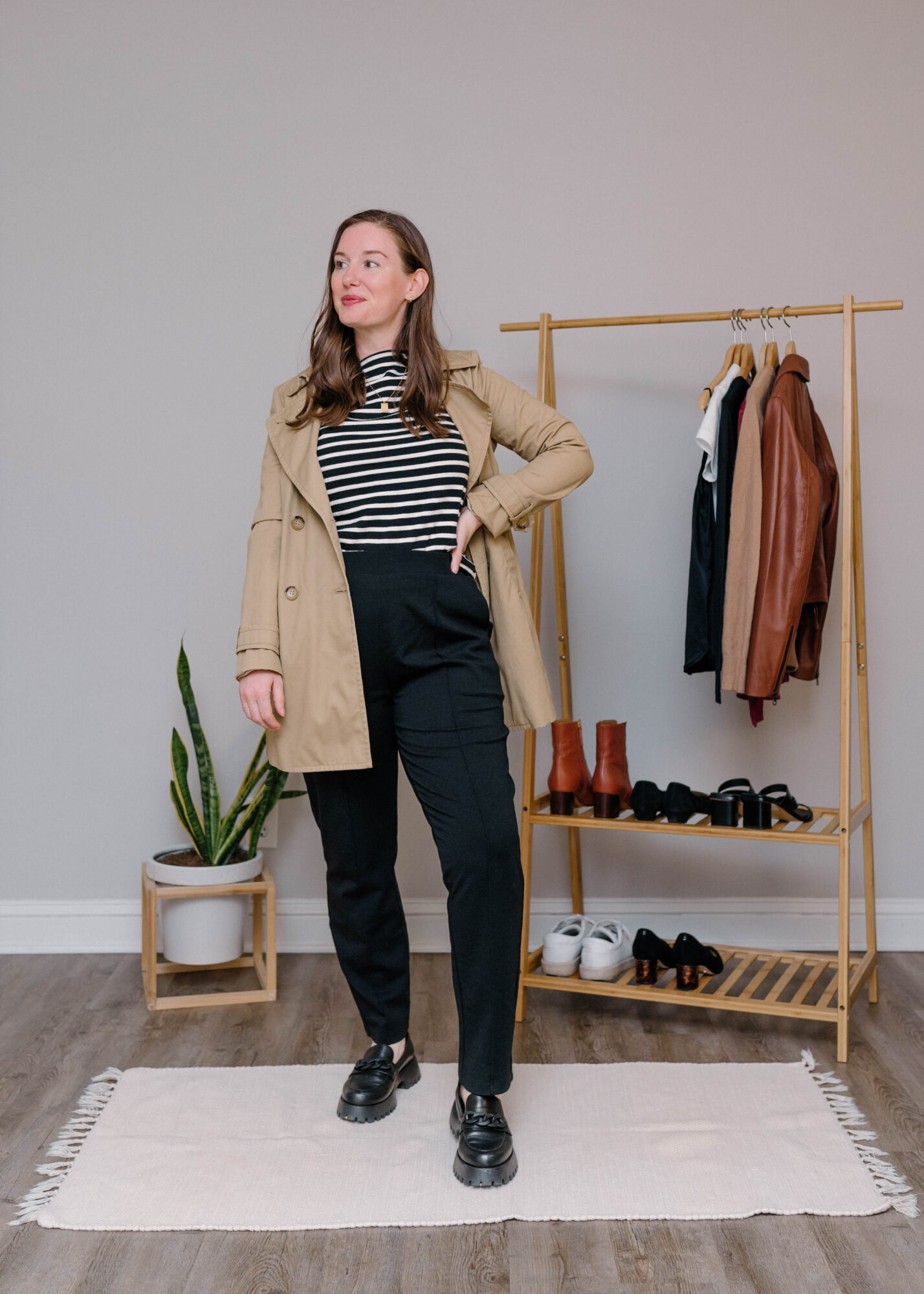 Alyssa wears the Rosso Pants with a trench, striped tee, and loafers