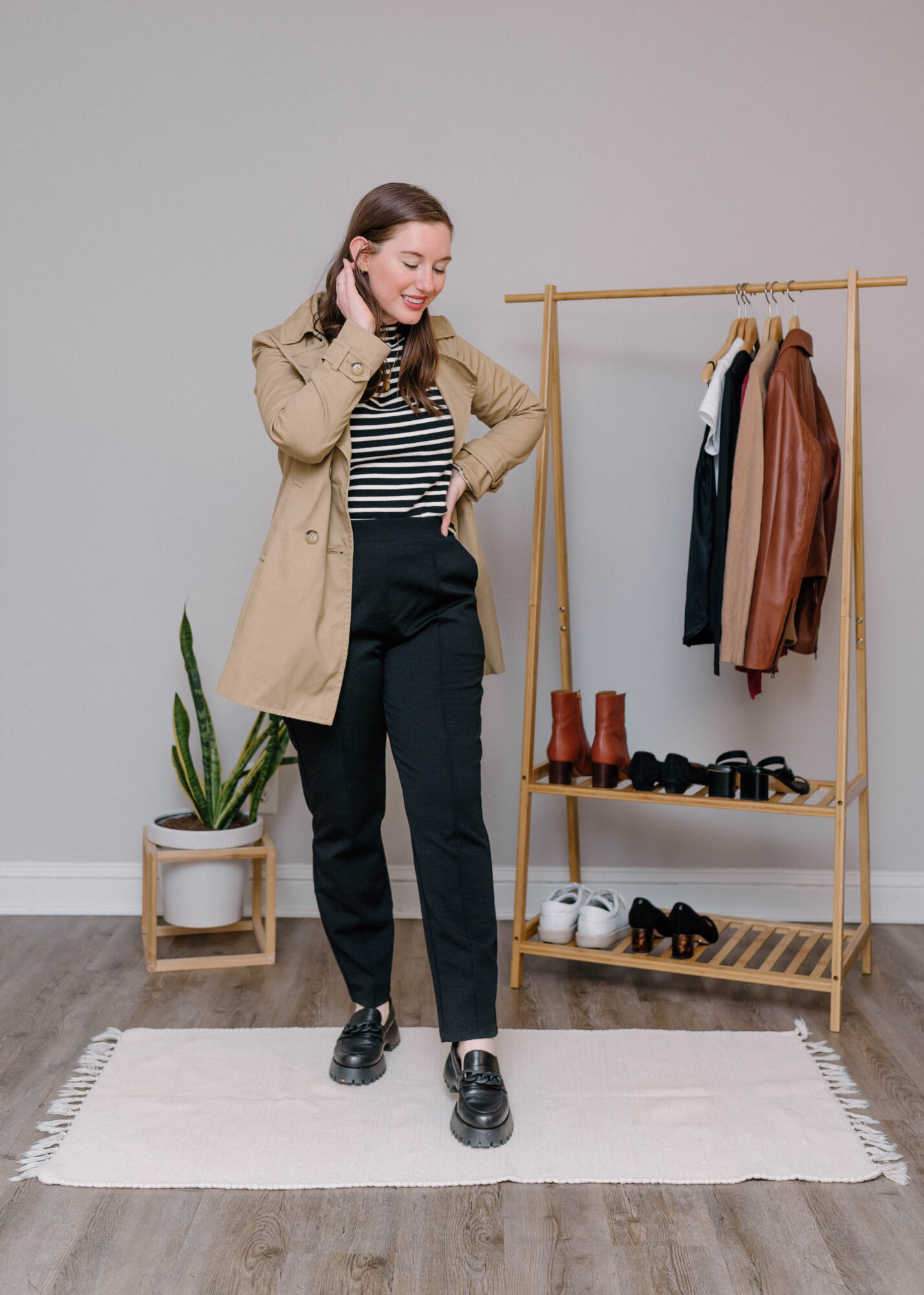 Alyssa wears the wool& Rosso pants with a striped shirt and a trench