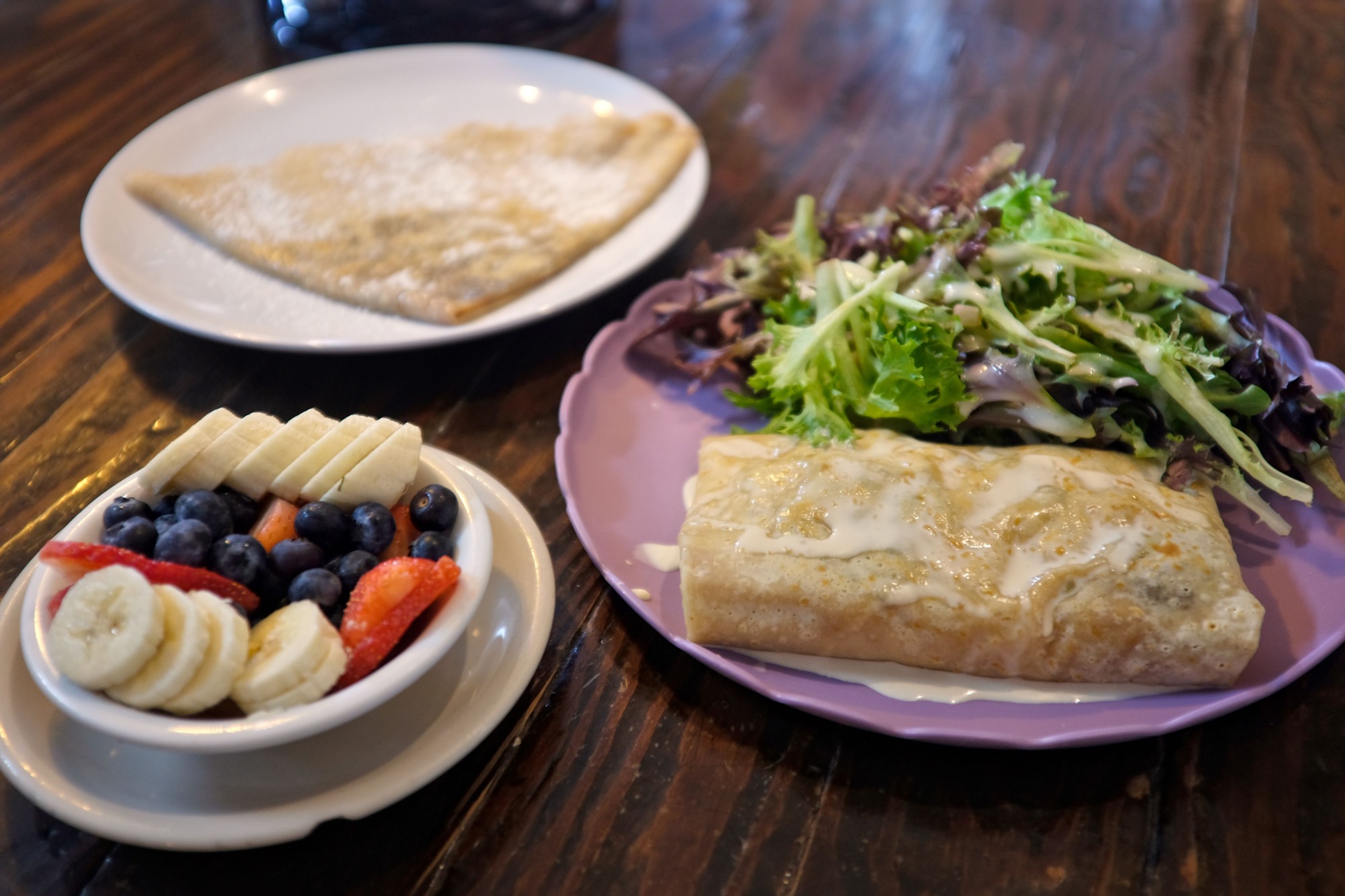 A sweet crepe, savory crepe, and a side of fruit