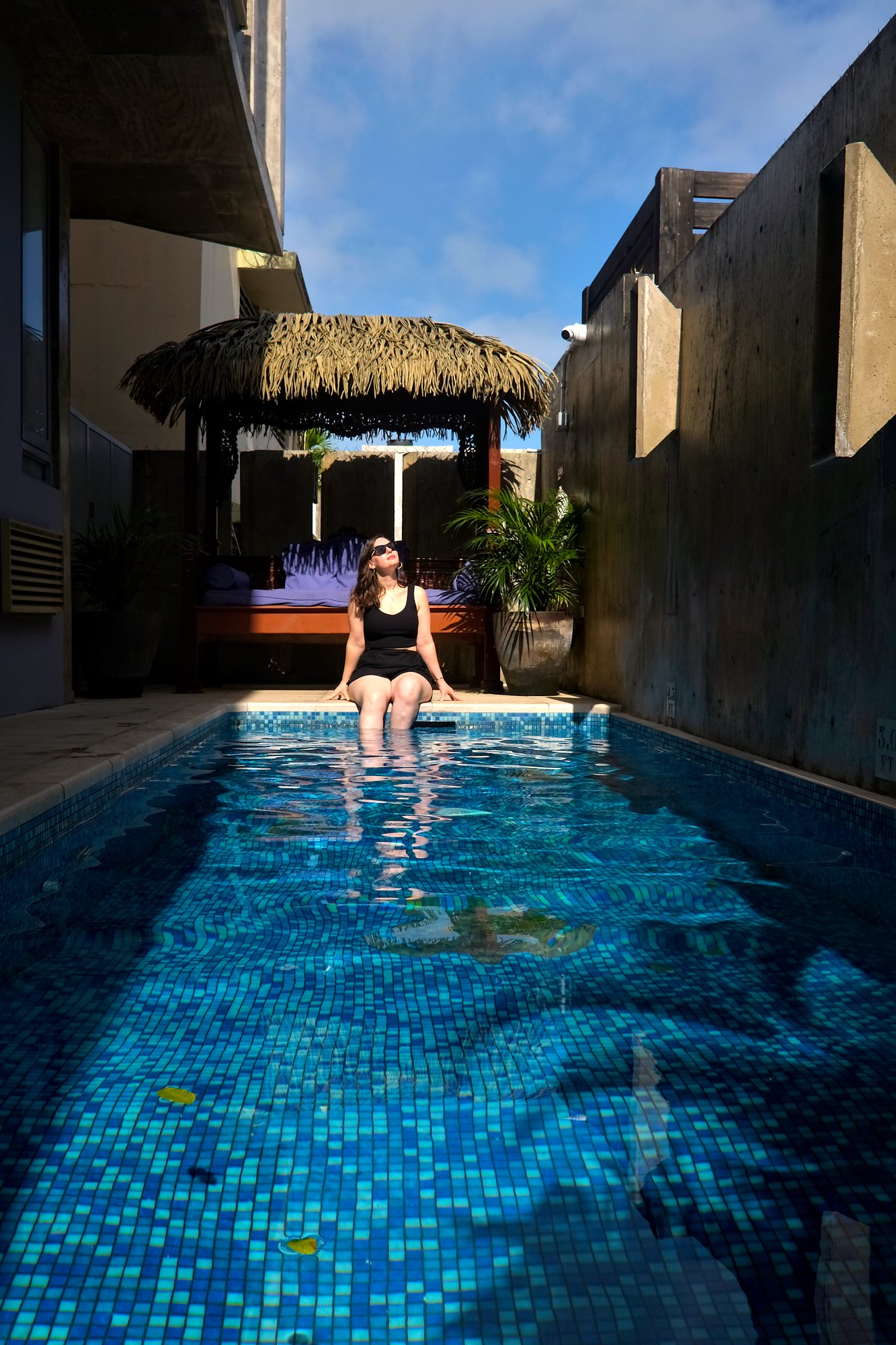 Alyssa sits by the pool at Dream Inn