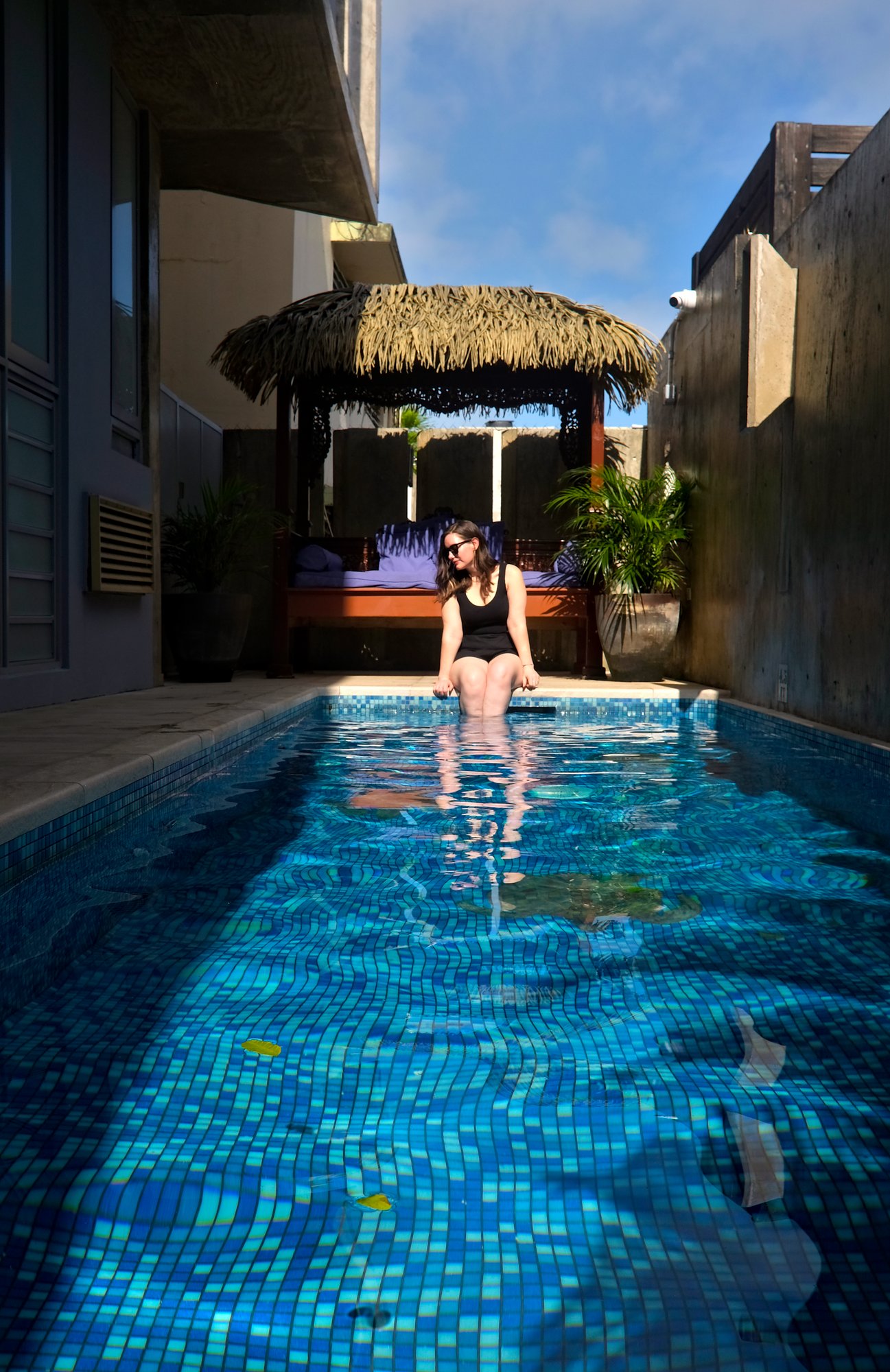 Alyssa sits by the pool at Dream Inn