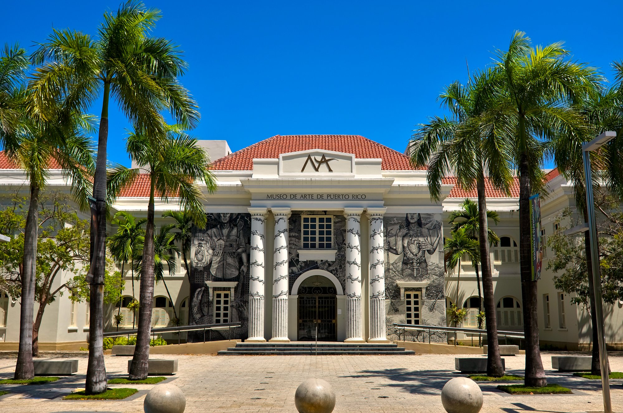 Exterior of the Museo de Arte de Puerto Rico, framed by palm trees