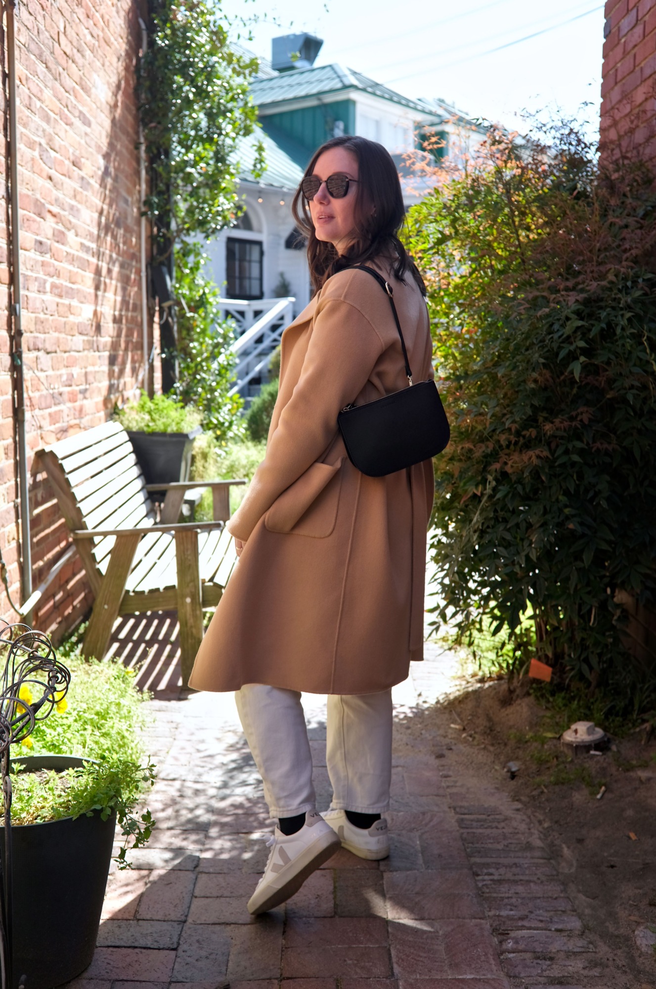 Alyssa walks down a charming alley in Pinehurst