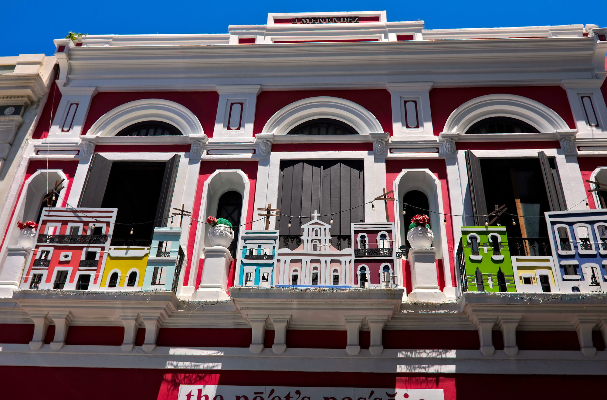 A diorama of churches line the top of a building