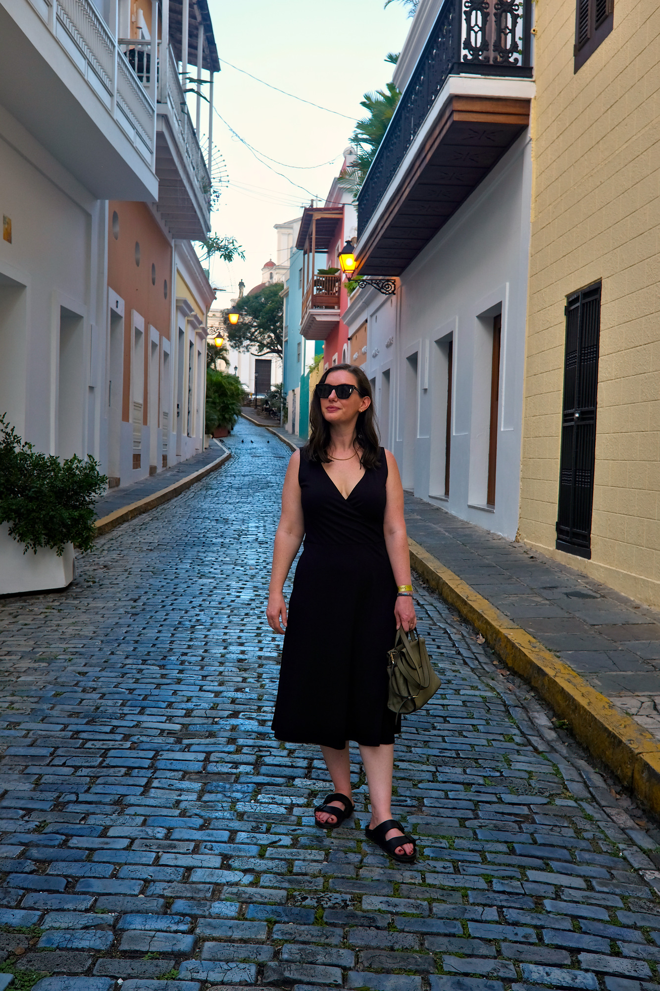 Alyssa stands on a cobblestone street in San Juan