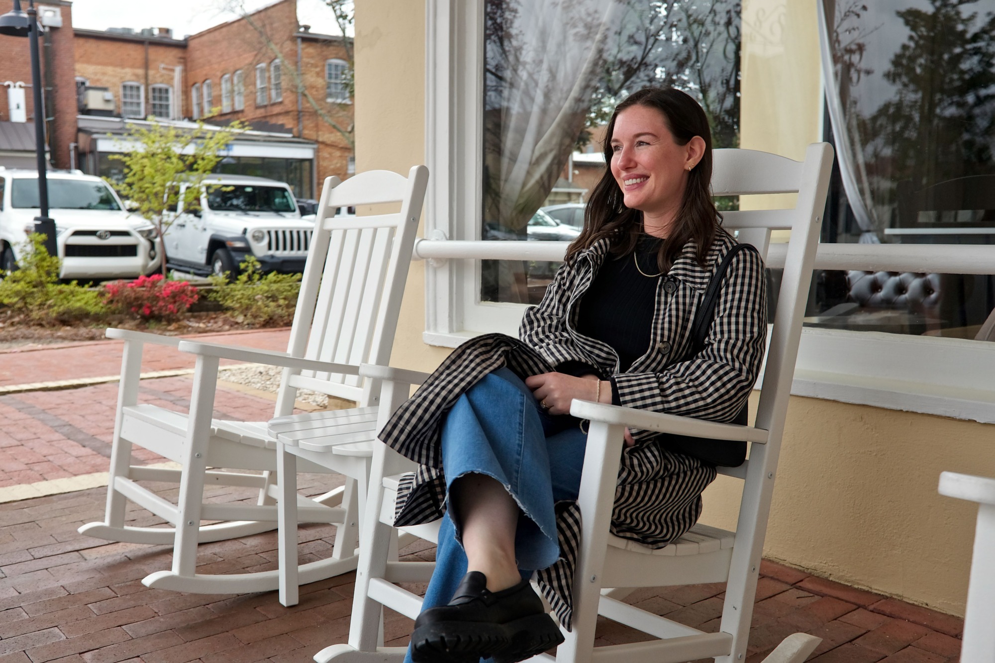 Alyssa rocks in a chair on The Jefferson Inn Porch