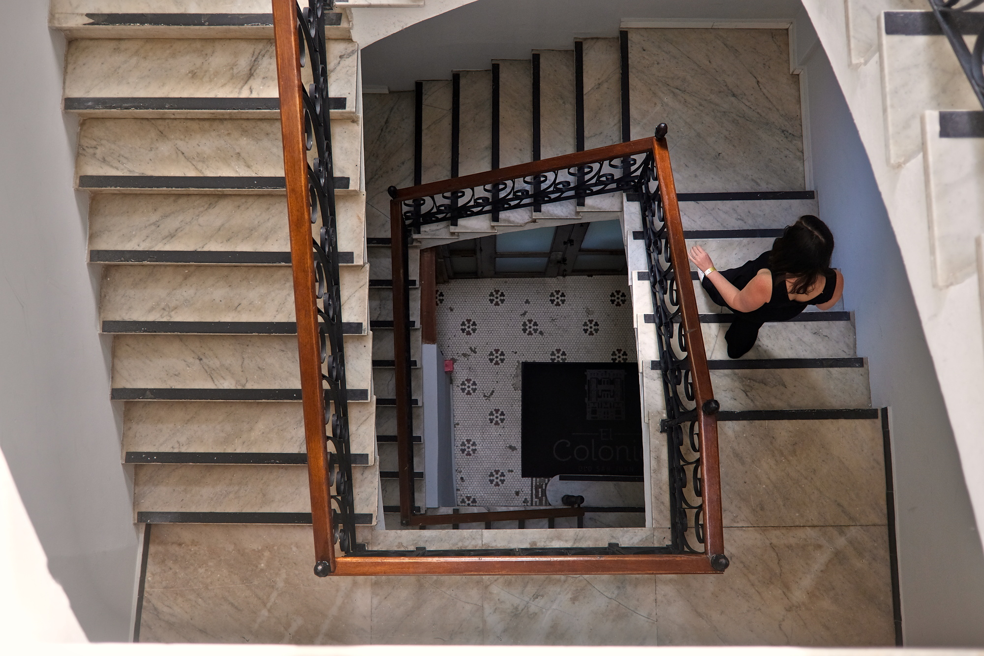 Alyssa descends the stairs at El Colonial
