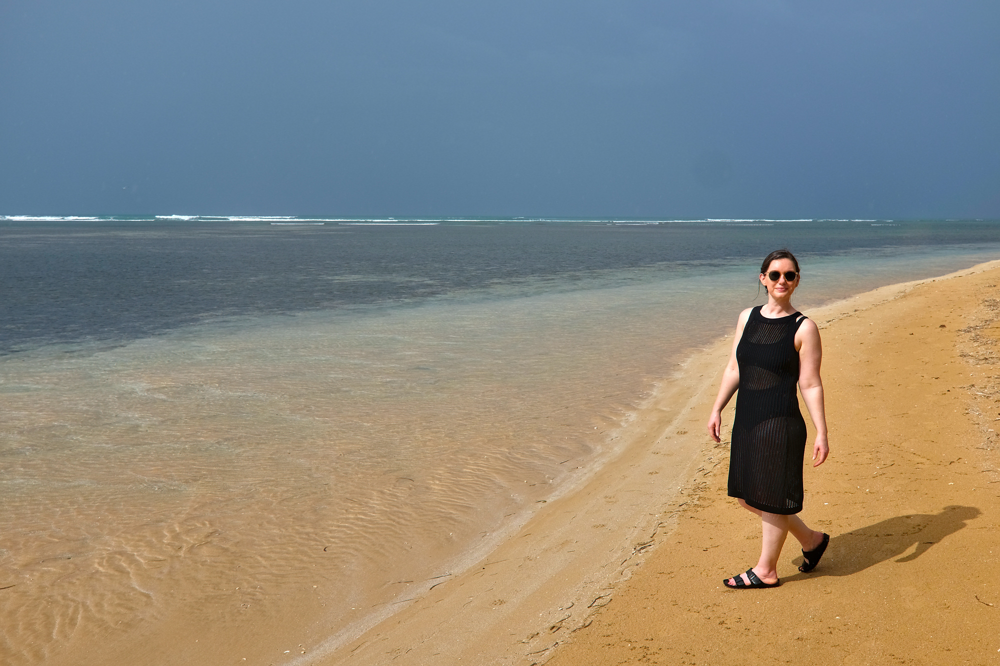 Alyssa walks on a beach in Puerto Rico