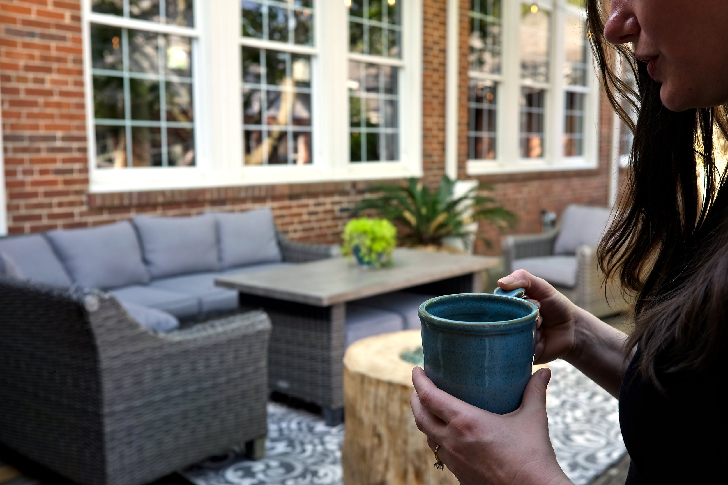 Alyssa on the deck at Sharon Manor, holding a cup of coffee
