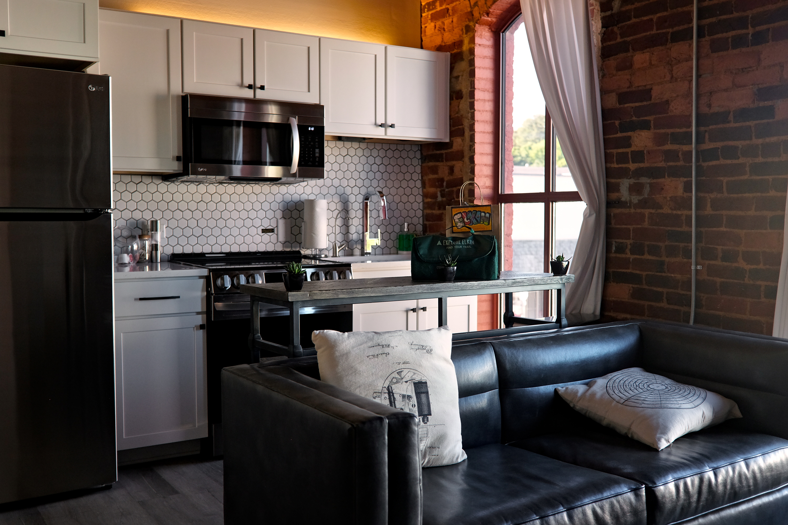 A living room and kitchen at Three Trails