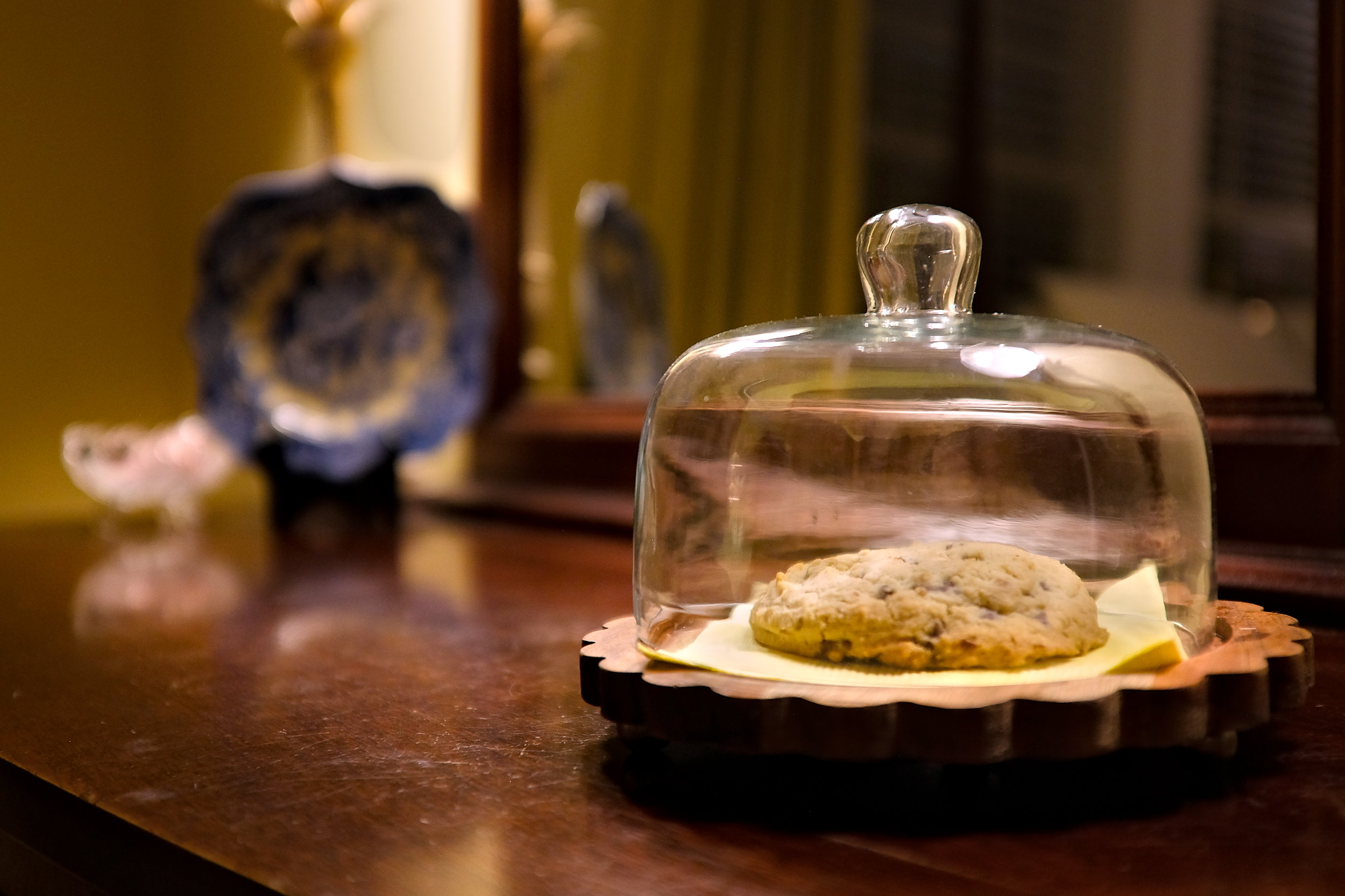 A chocolate chip cookie in a cloche