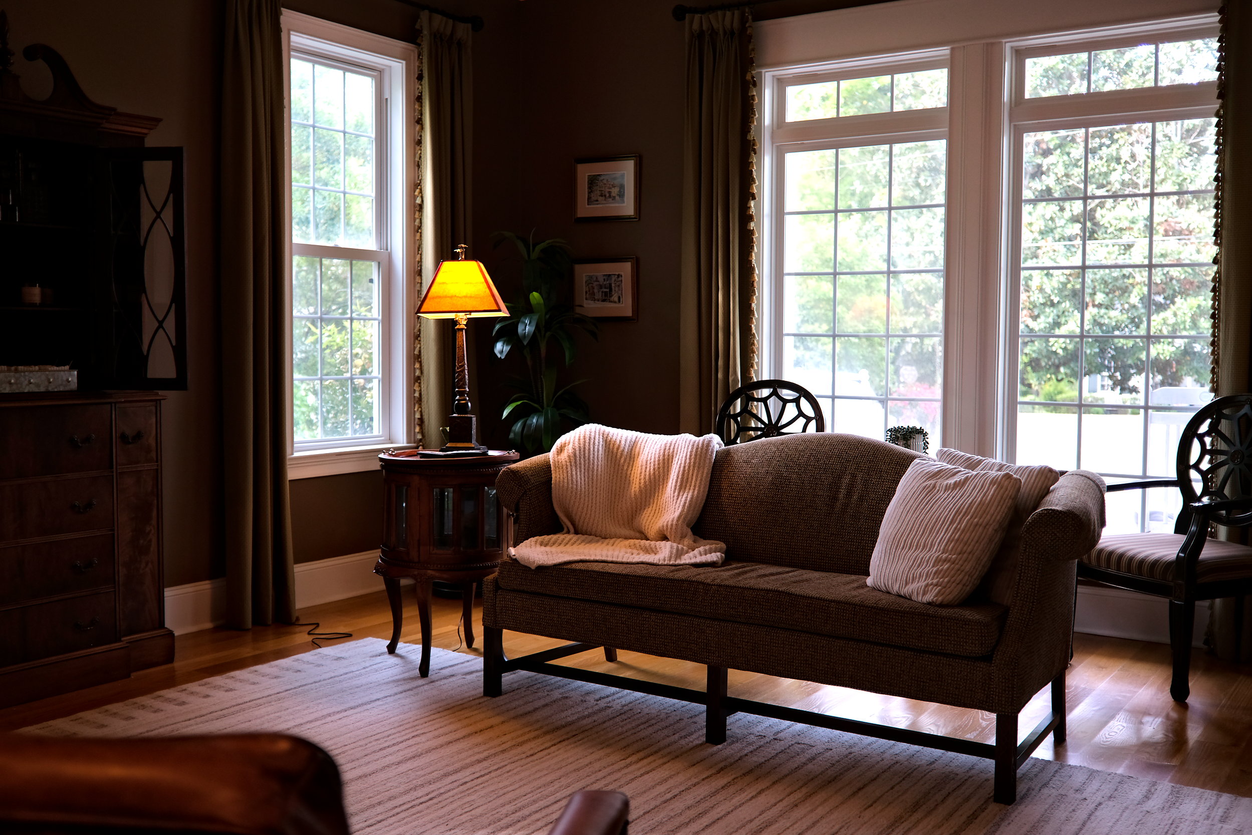 A living room with an inviting sofa and tons of natural light