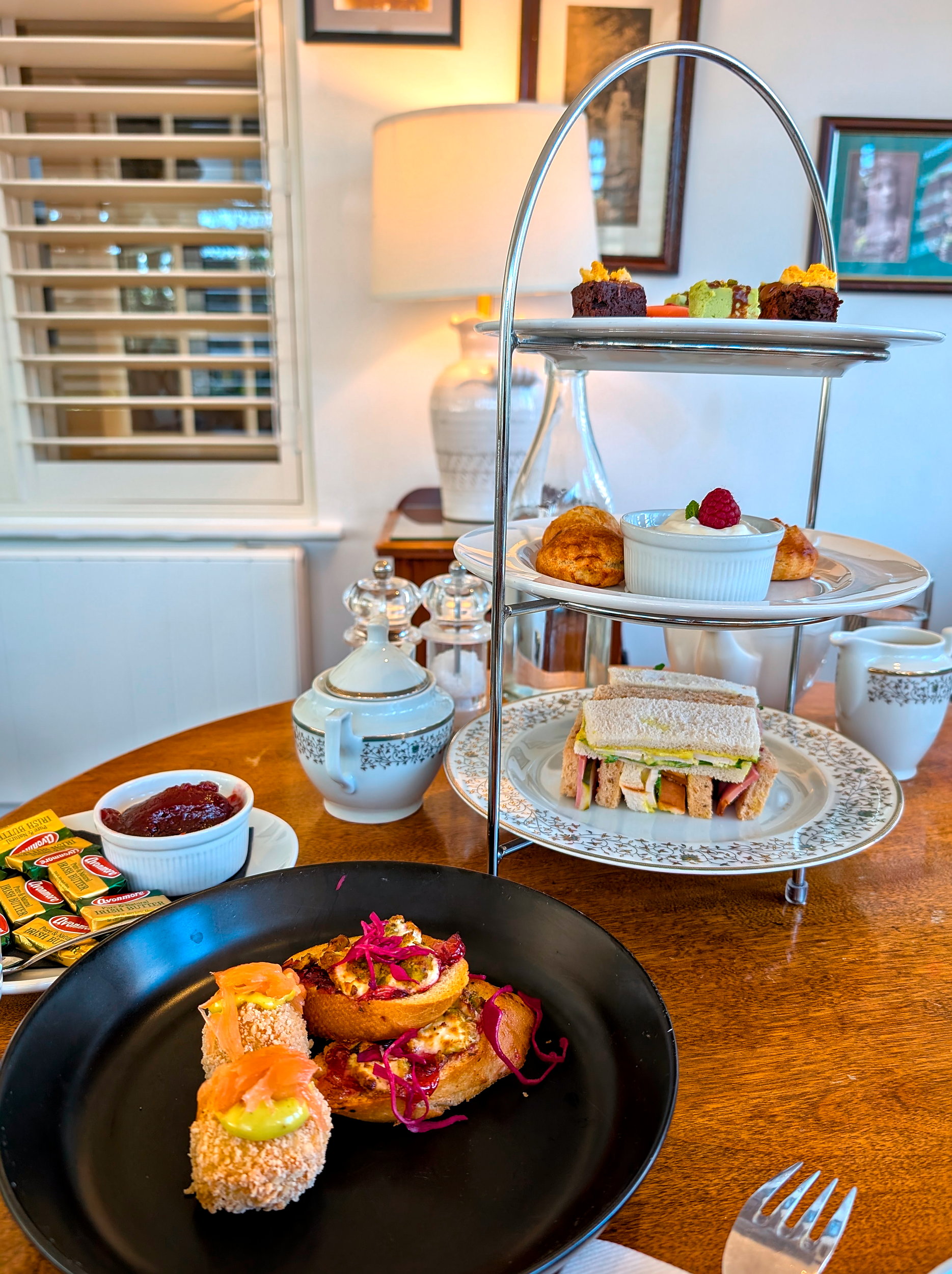 A tower of small sandwiches, toasts, scones, and desserts at Mrs. Benners Tea