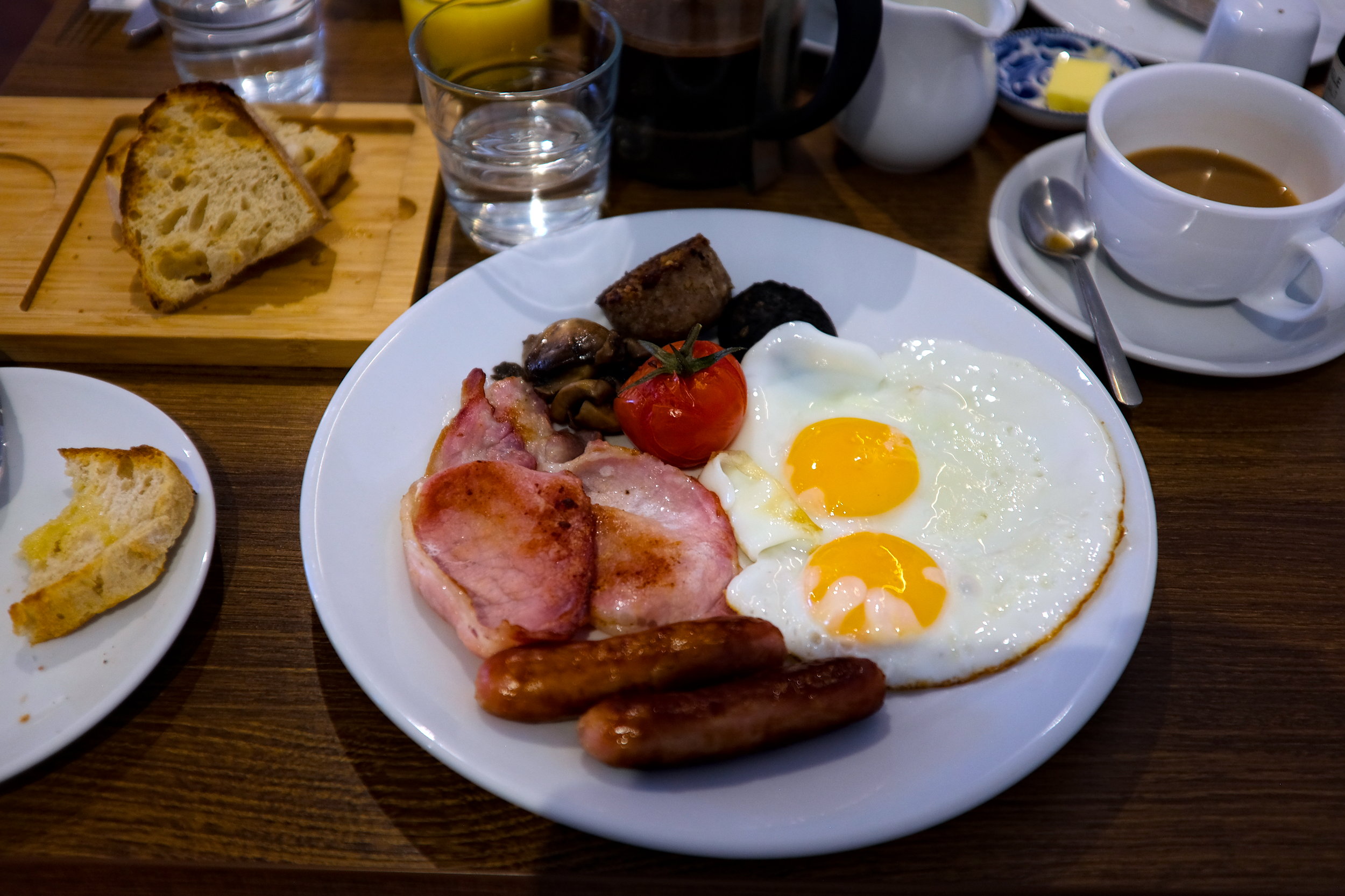 Colorful breakfast plates with a spread of toast, eggs, sausages, and Irish breakfast staples, beautifully presented on a cozy dining table.