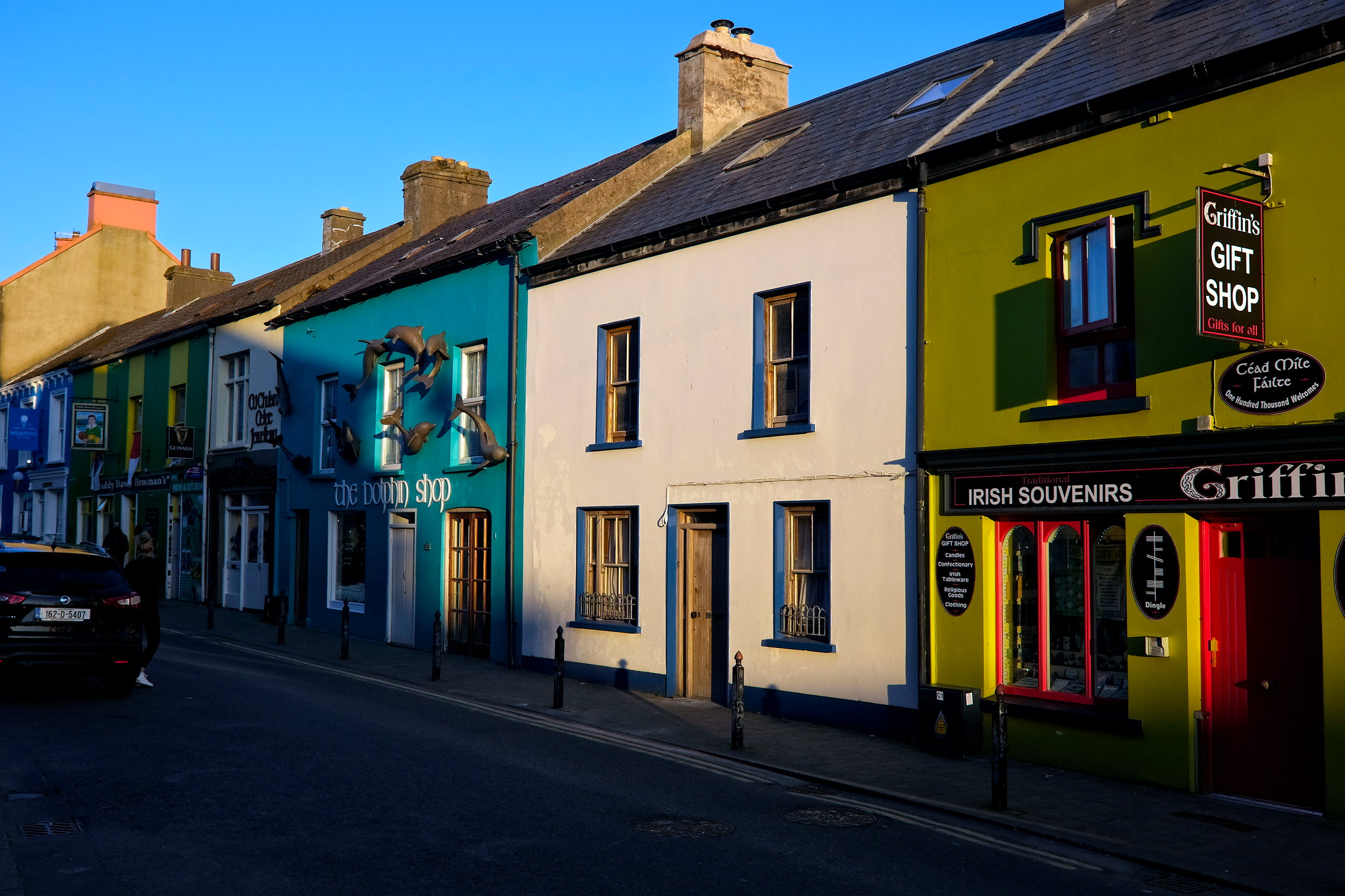 Charming street view in Dingle lined with colorful shopfronts