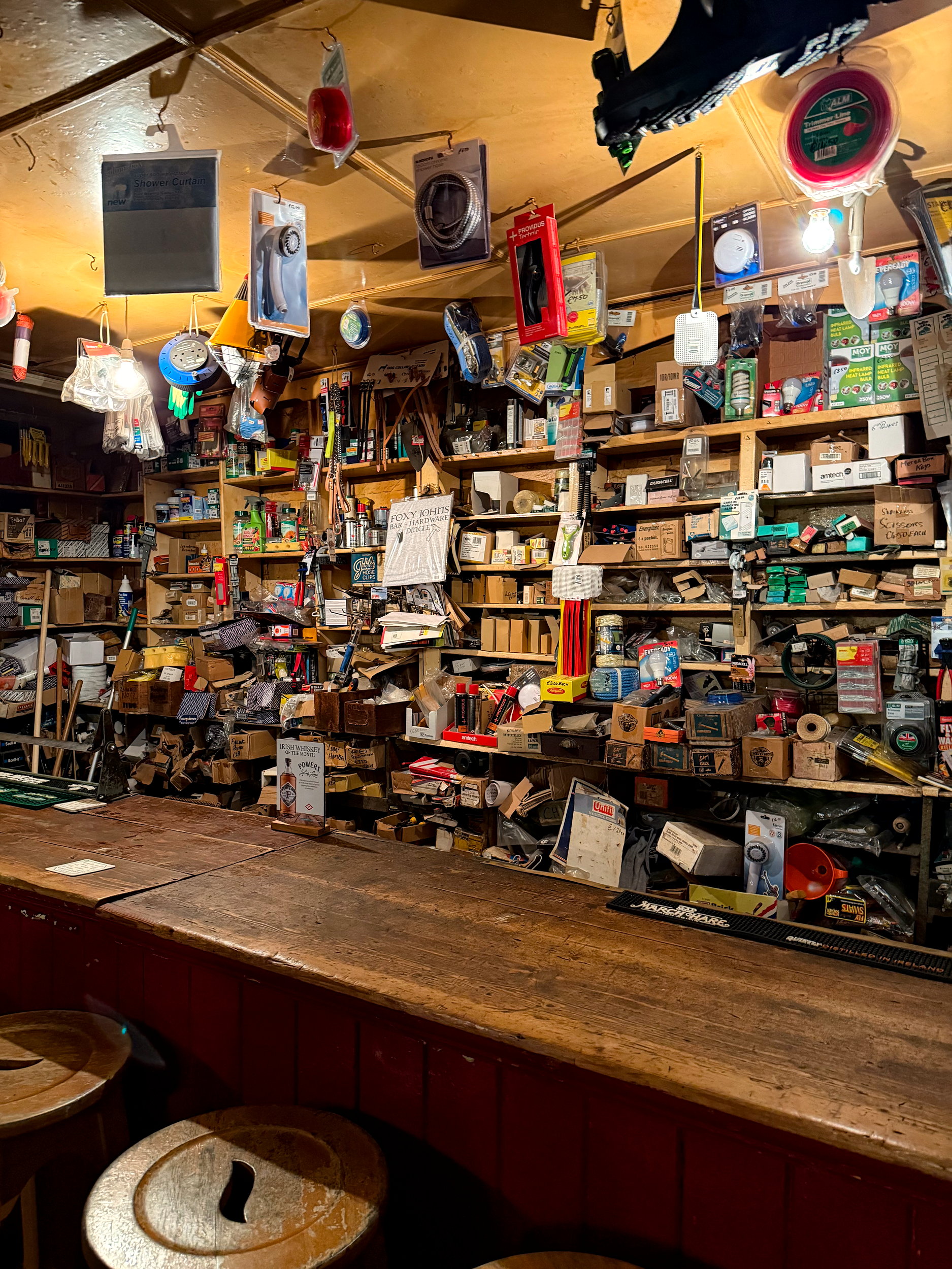 Inside Foxy John’s hardware store area, shelves are stocked with tools, paint cans, and supplies, blending old-school charm with practical, everyday goods.