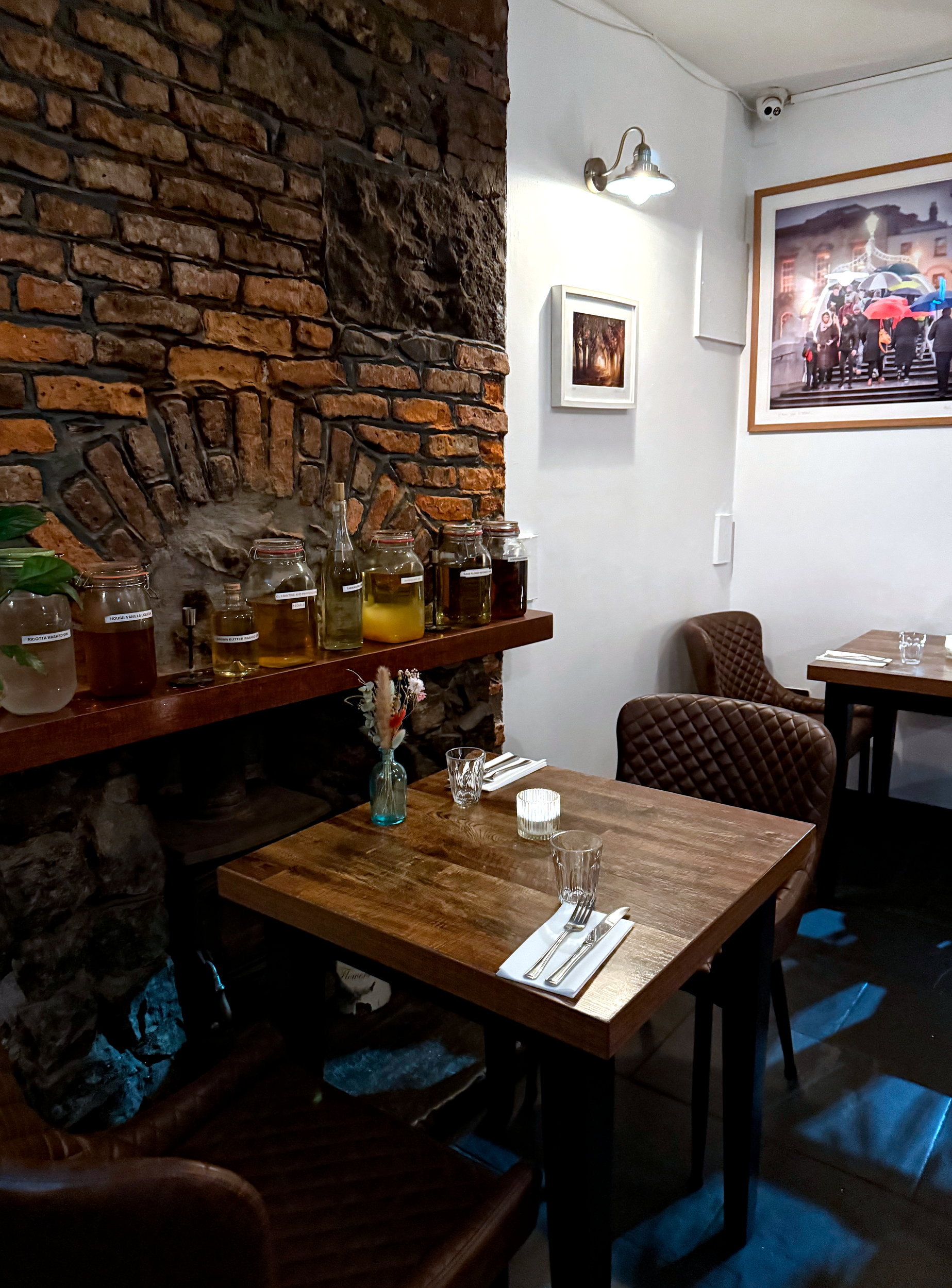 Warm and modern interior of Rúibín in Galway, with wood-accented furnishings, ambient lighting, and greenery creating a cozy, upscale dining atmosphere.