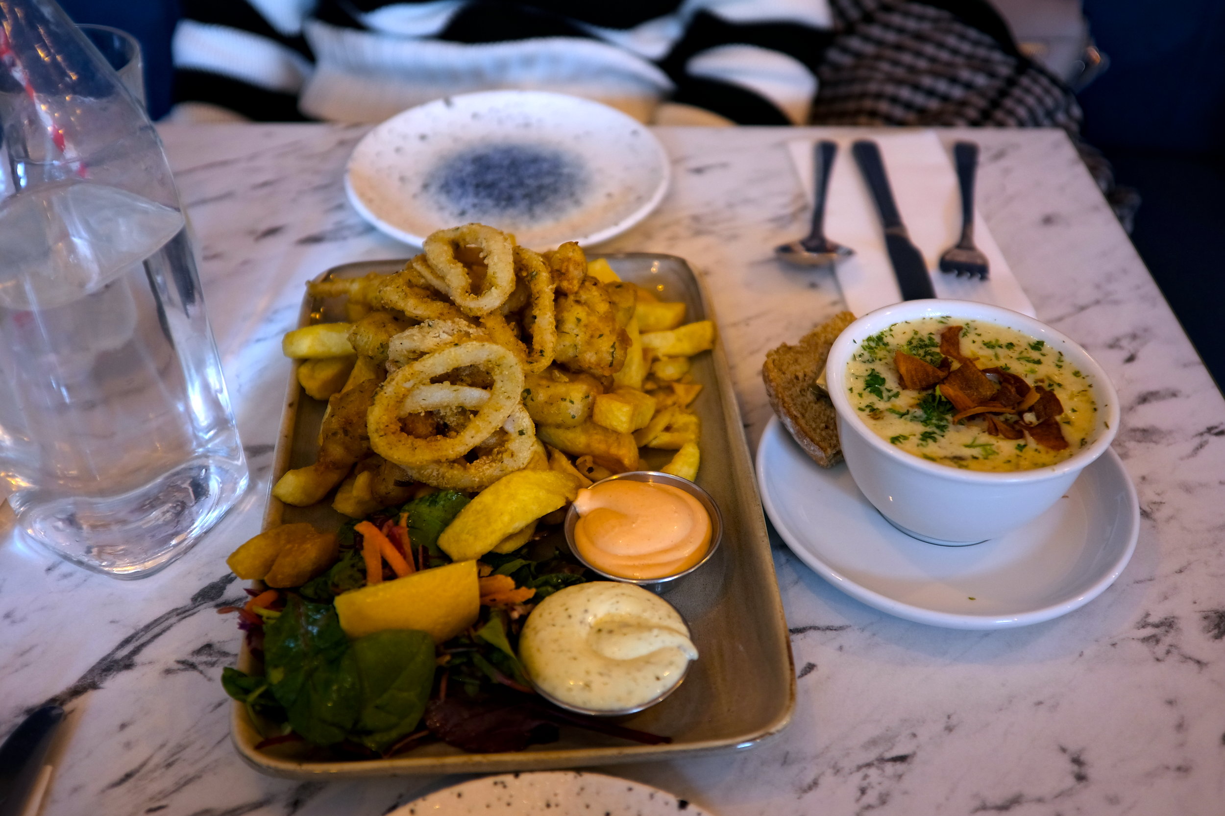 A platter of fried seafood, chips, and chowder from The Fish Box