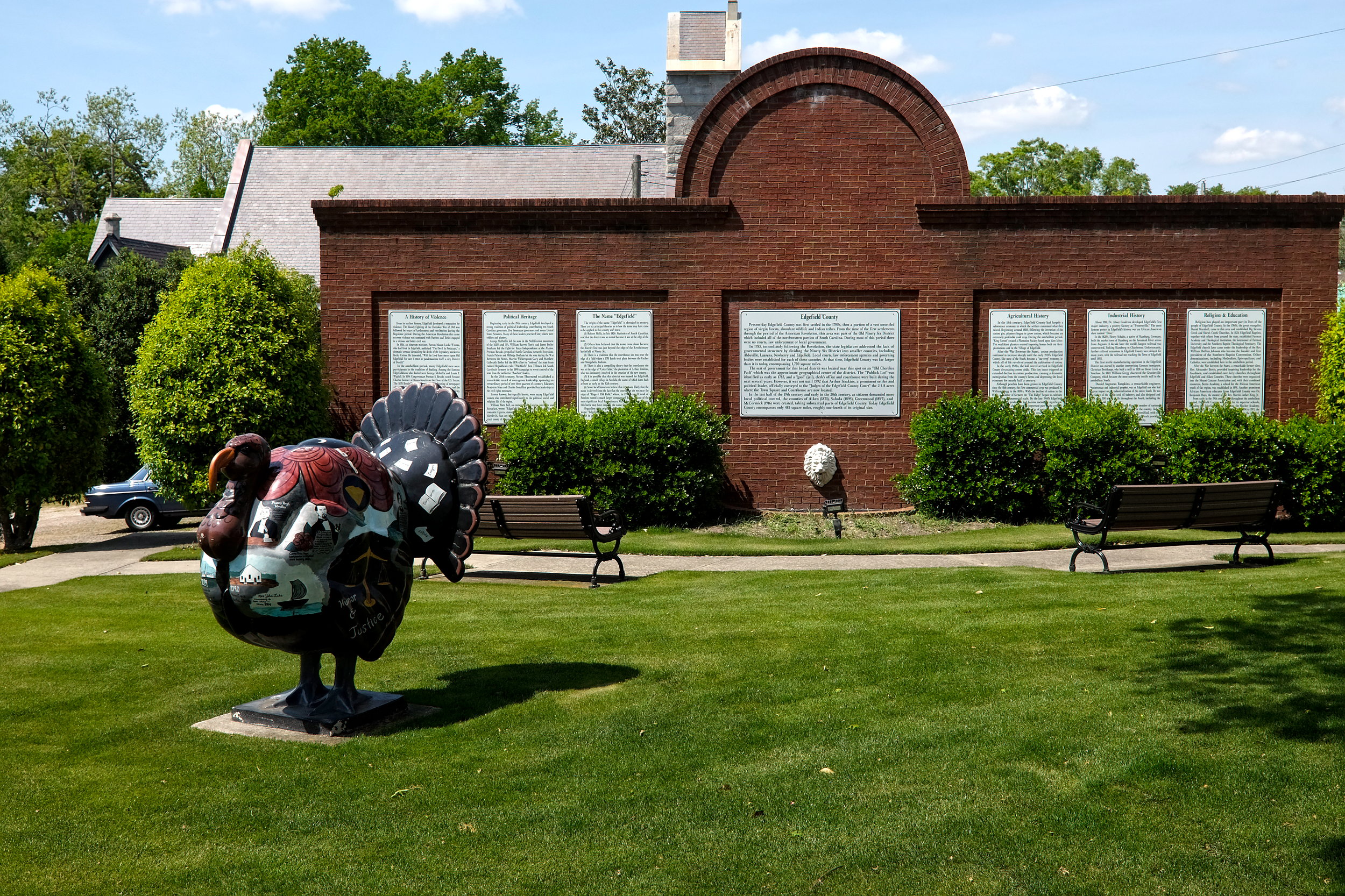 A turkey in front of a sign telling Edgefield's story