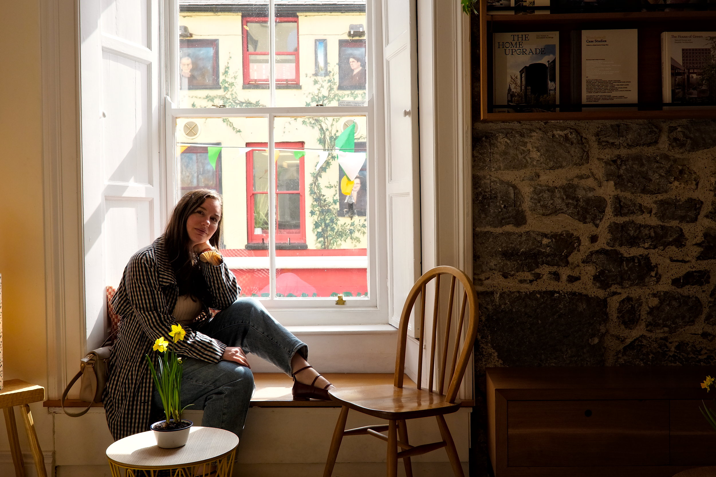 Alyssa sits in a window at Coffewerk + Press in Galway, Ireland, and looks at the camera