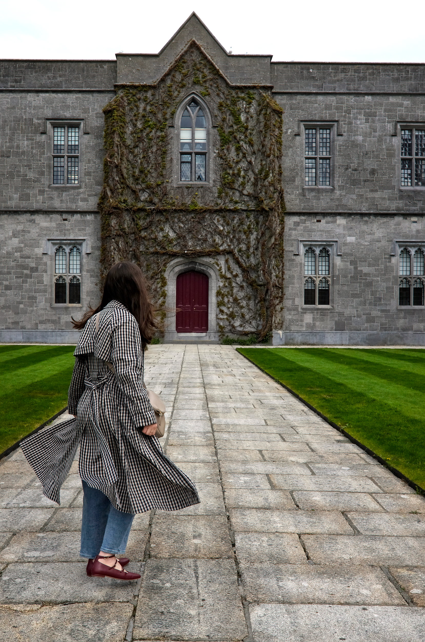 Alyssa faces a wall in the interior of the University of Galway's Quadrangle