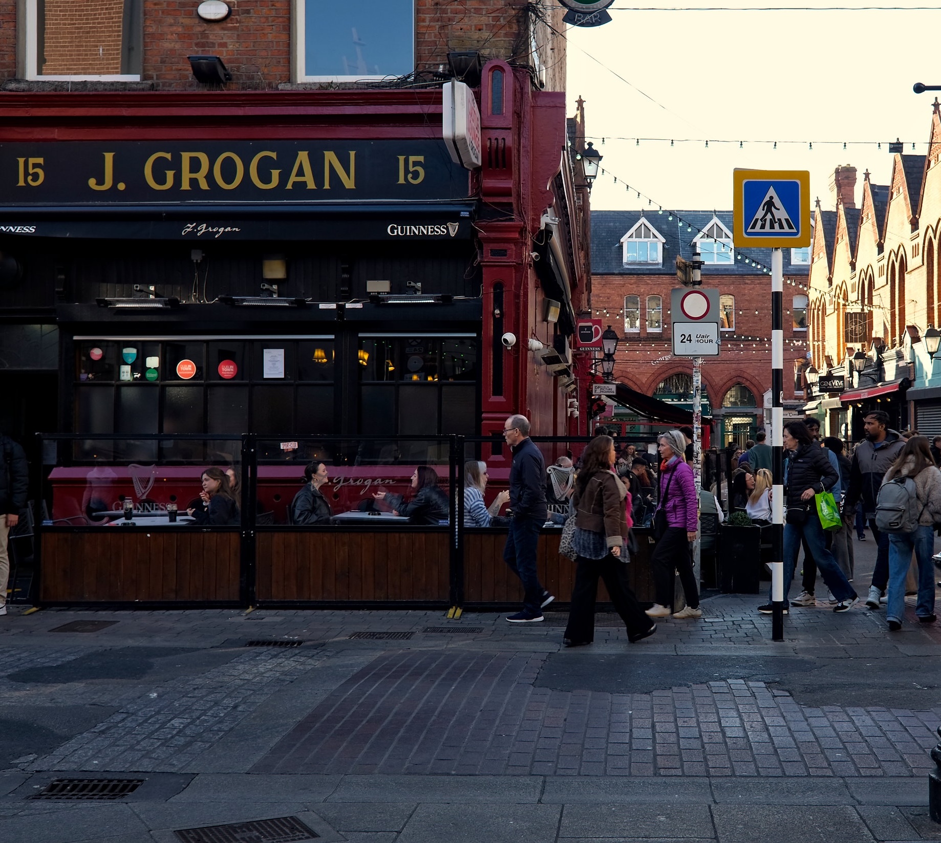People stroll outside Grogan's Castle Lounge