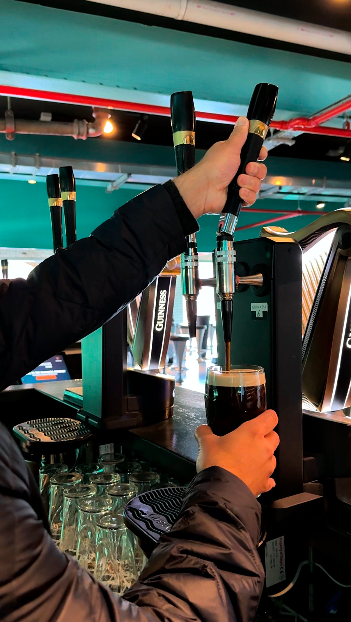 Michael finishes pouring a pint at the Guinness Academy