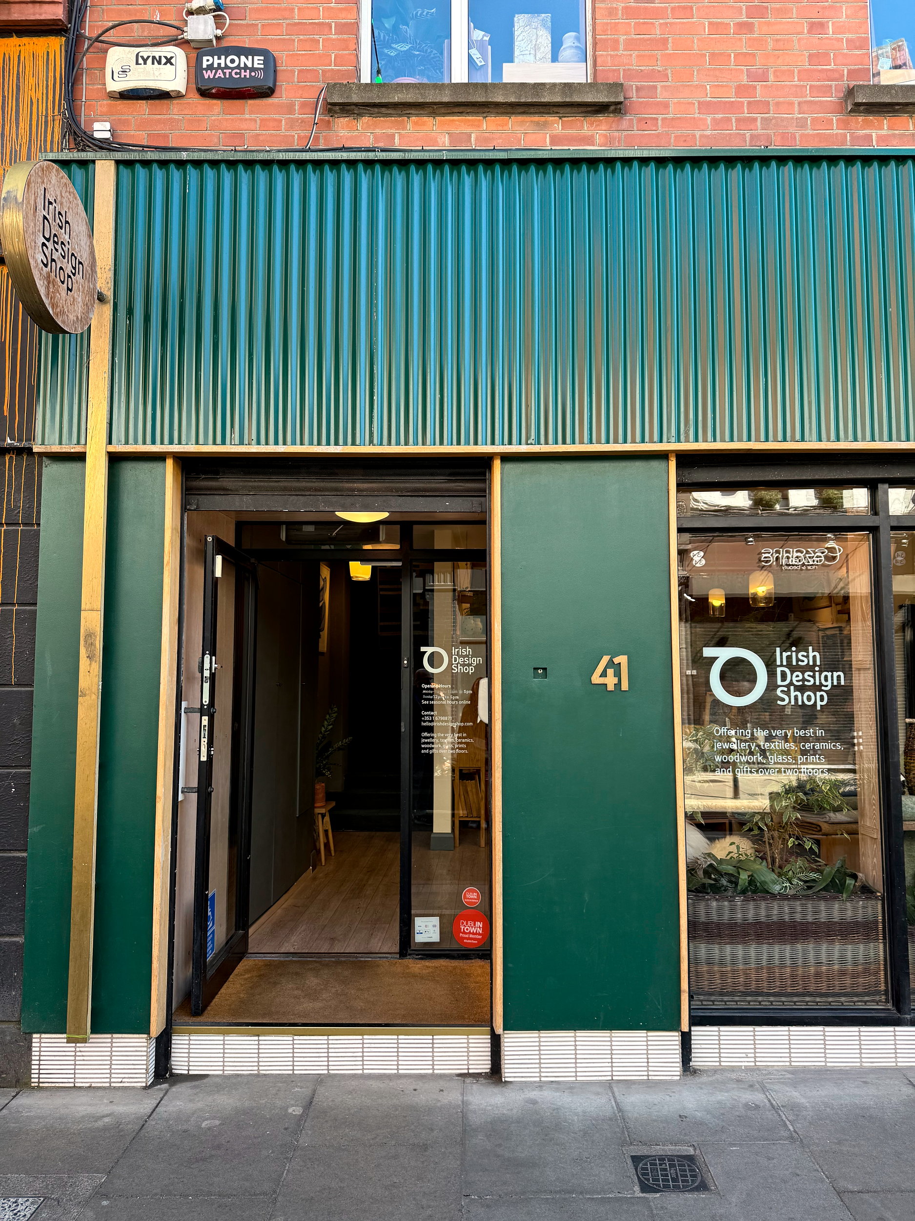 Exterior of Irish Design Shop, with a green facade and large windows